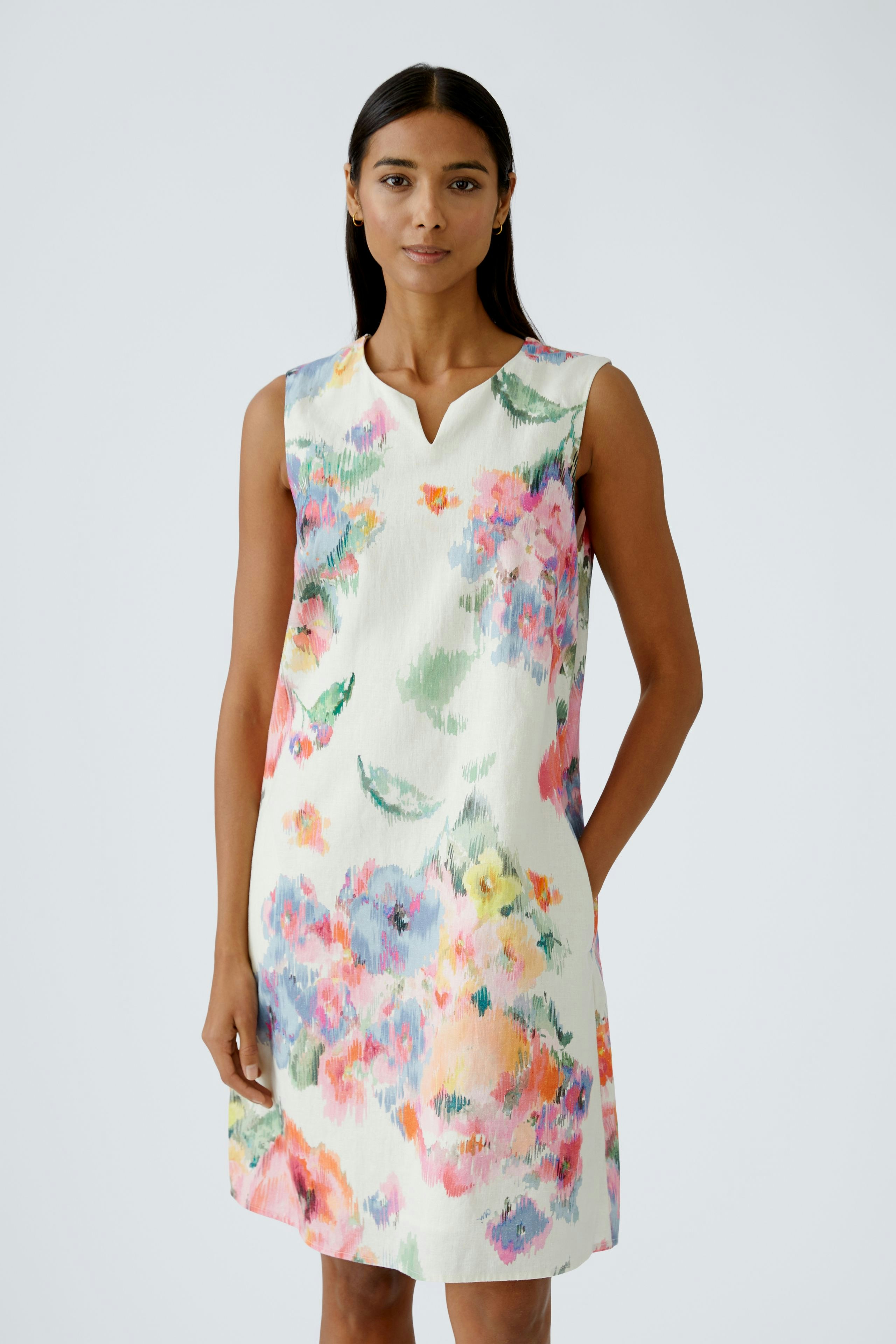 Floral A-line dress: A woman in a sleeveless dress with vibrant flowers, perfect for summer.