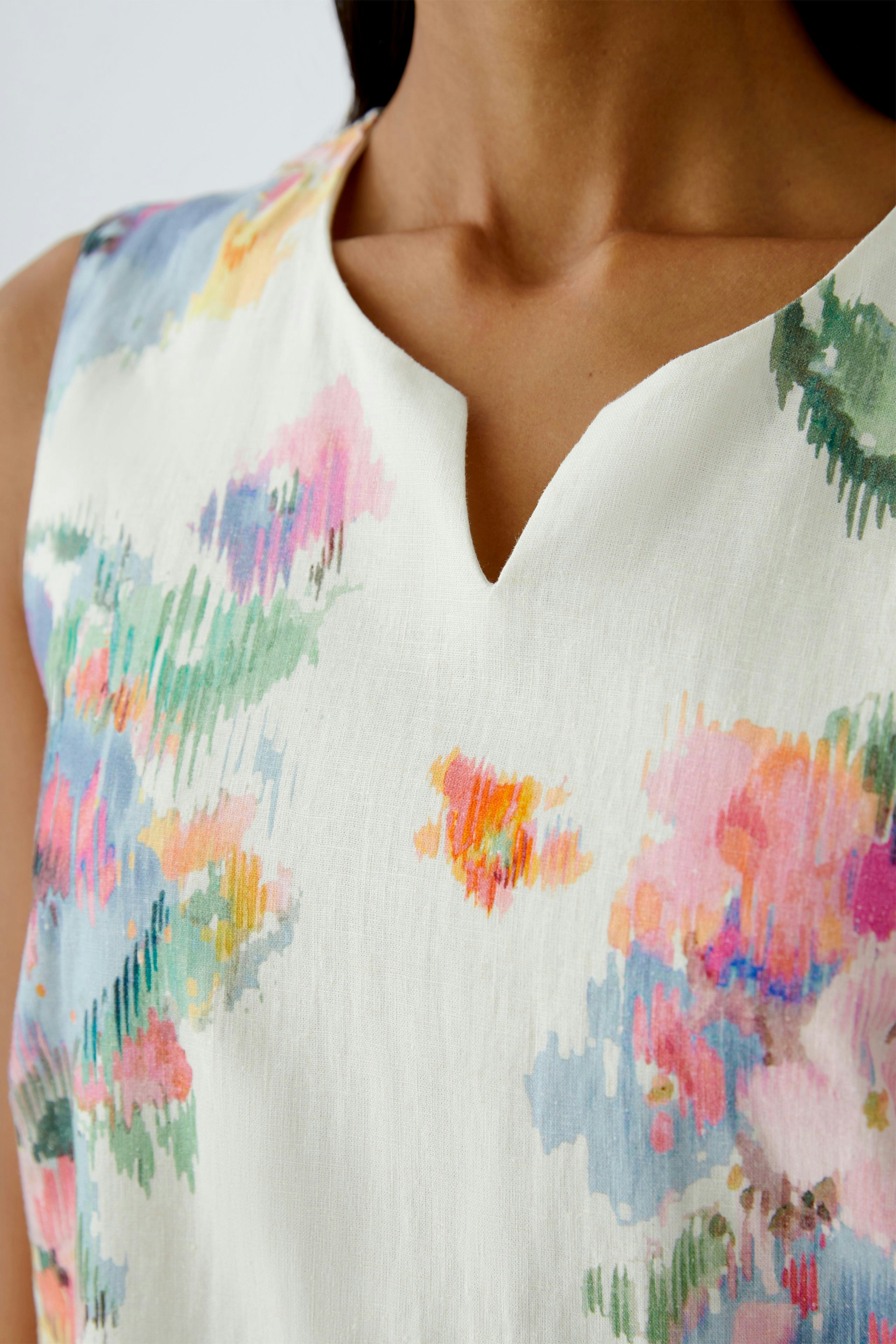 Floral A-line dress: Woman in a sleeveless dress with vibrant floral patterns, perfect for summer.