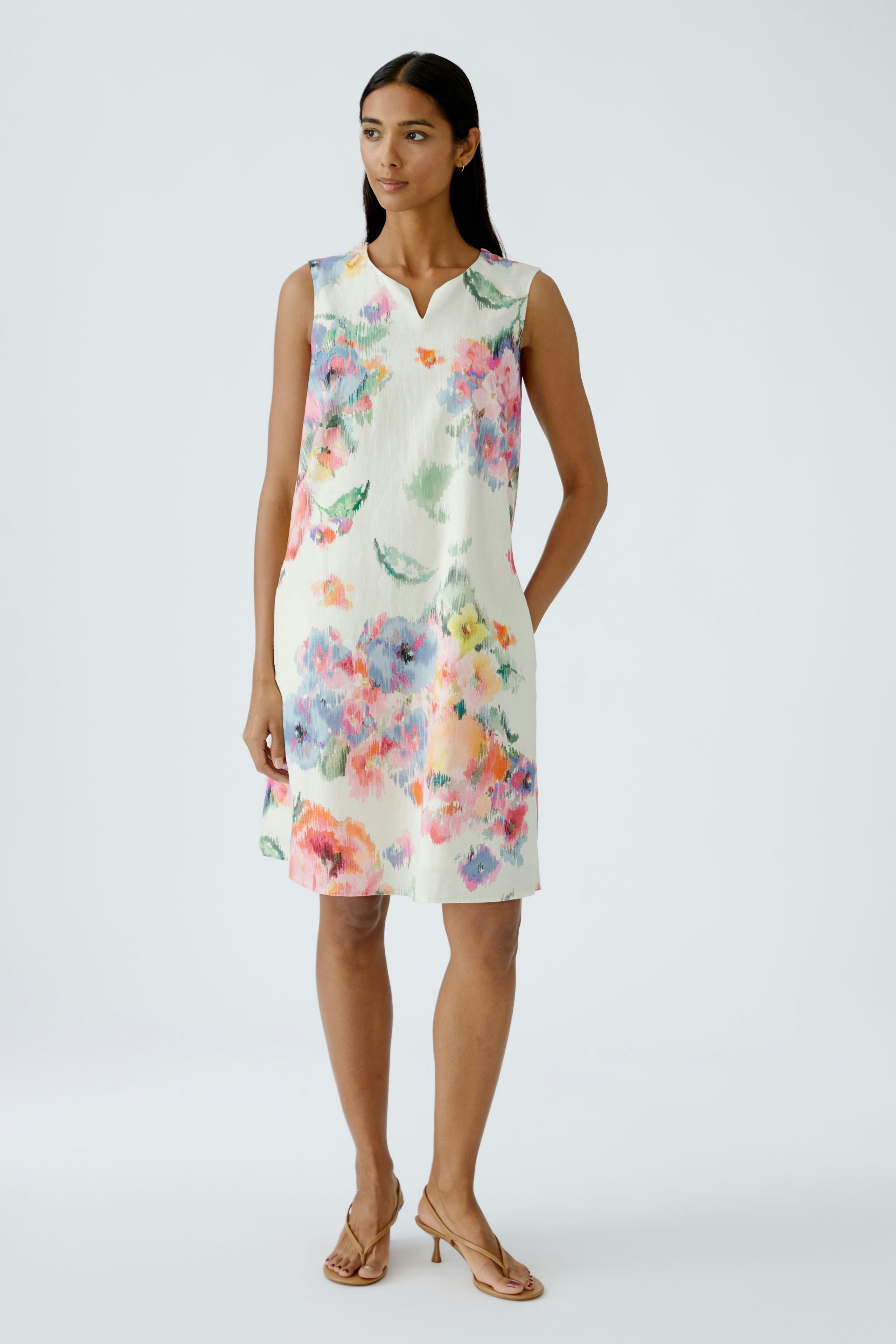 Floral A-line dress: A woman in a sleeveless dress with vibrant flowers, perfect for warm days.