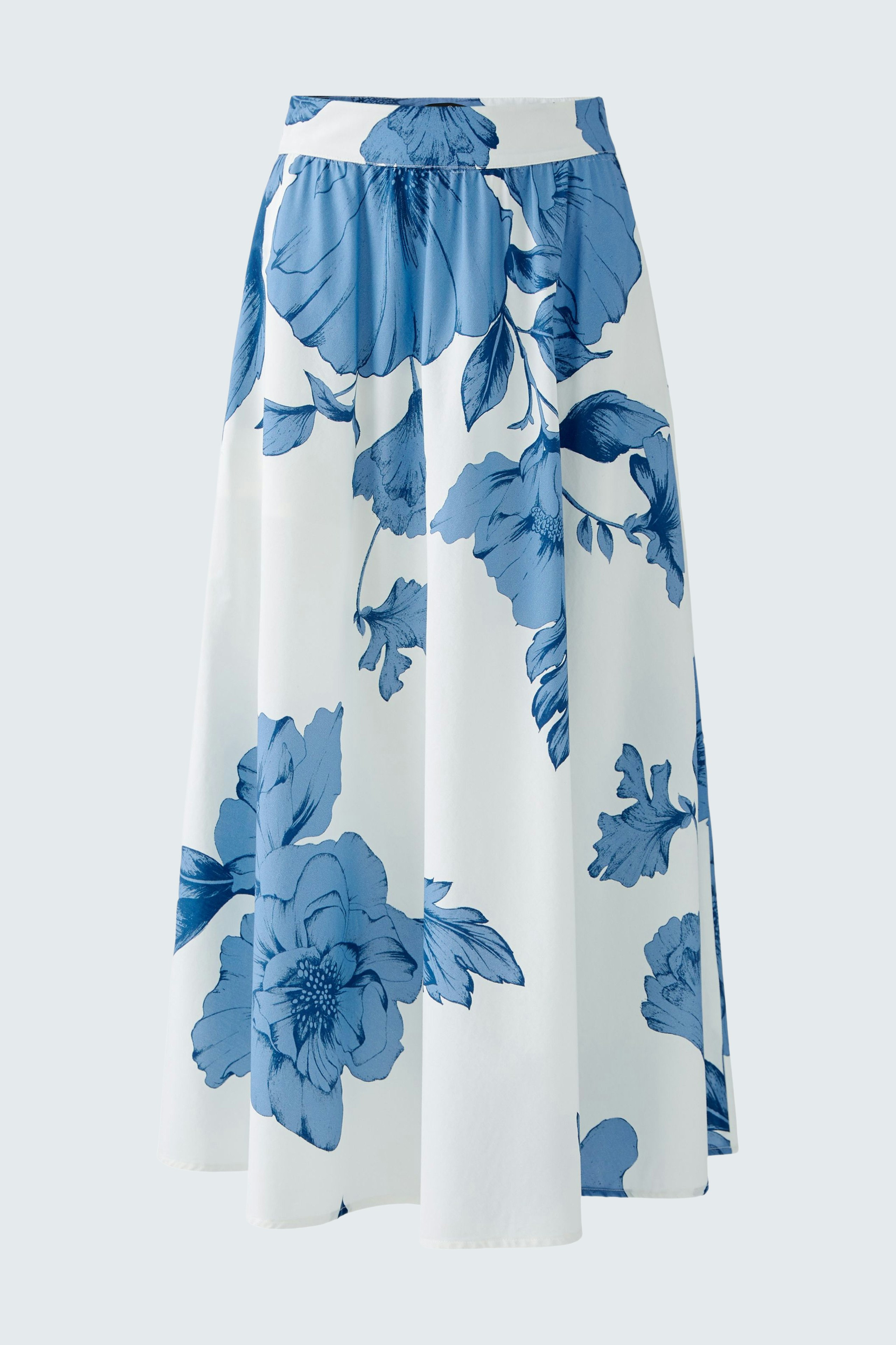 Elegant A-line skirt: A woman in a floral design skirt with blue and white colors, perfect for any occasion.