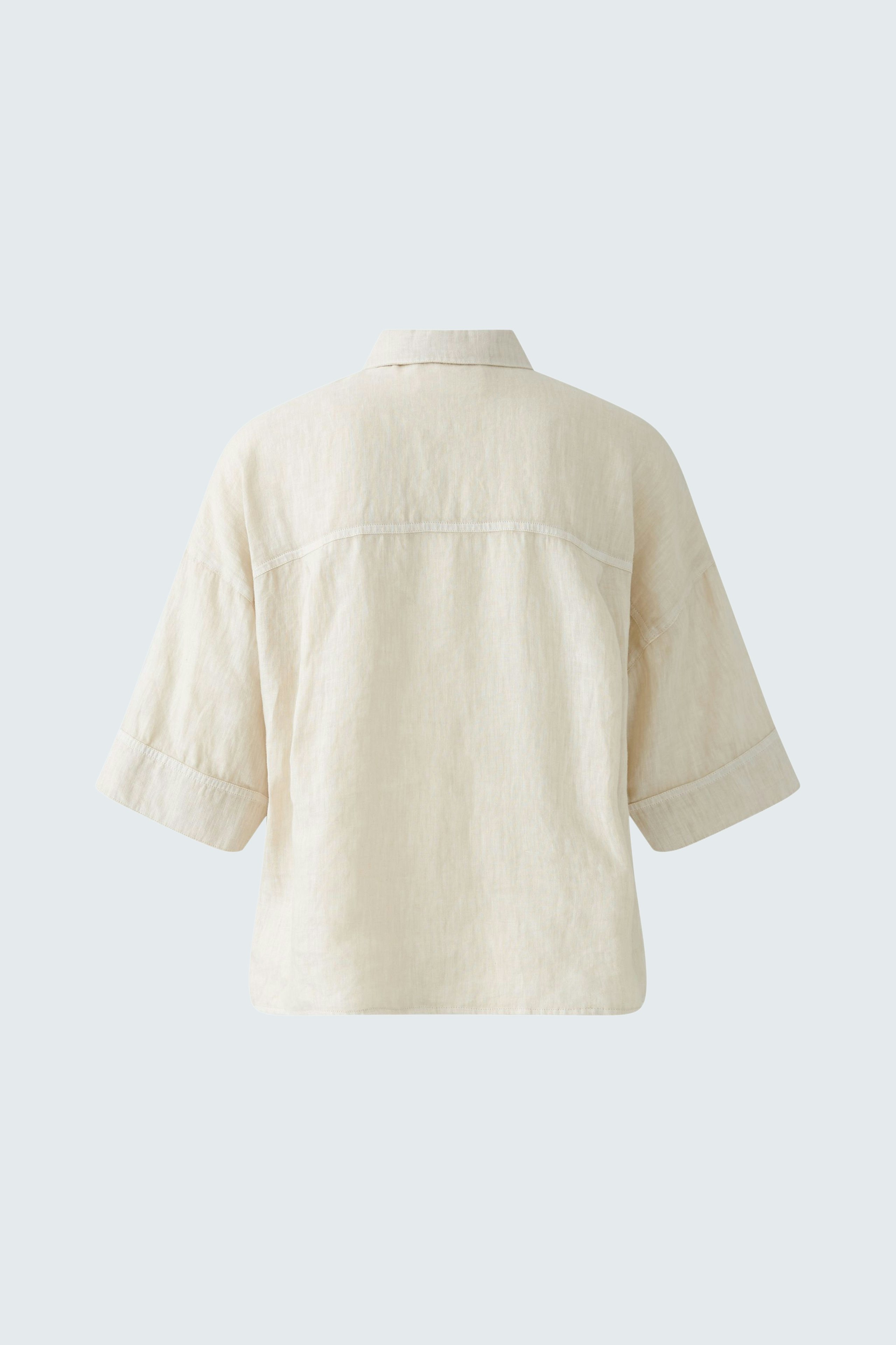 Stylish women's blouse: Back view of a light beige blouse with short sleeves and a relaxed fit.