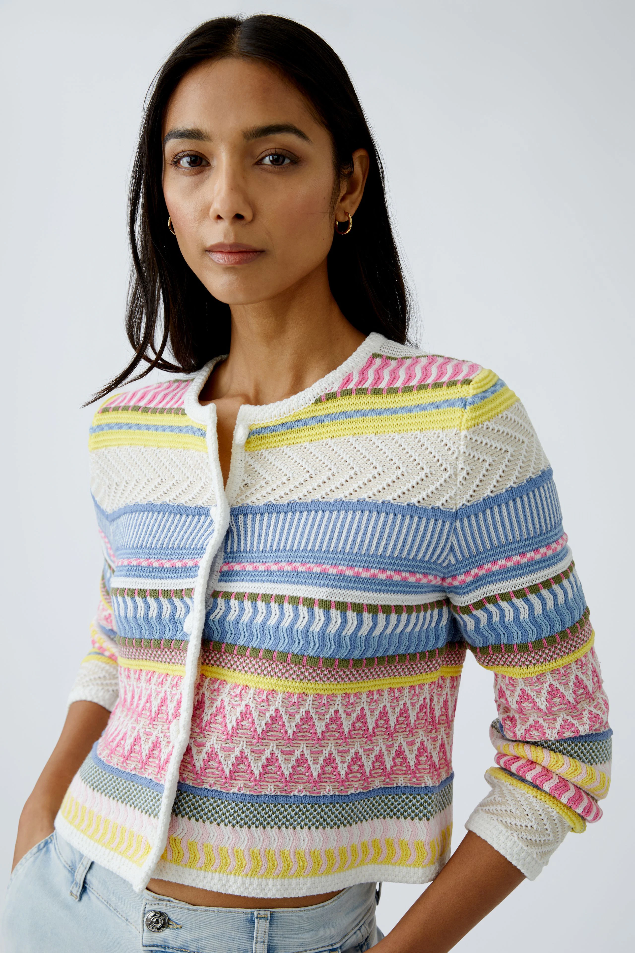 Stylish women's cardigan: A woman in a colorful knitted cardigan with intricate patterns.