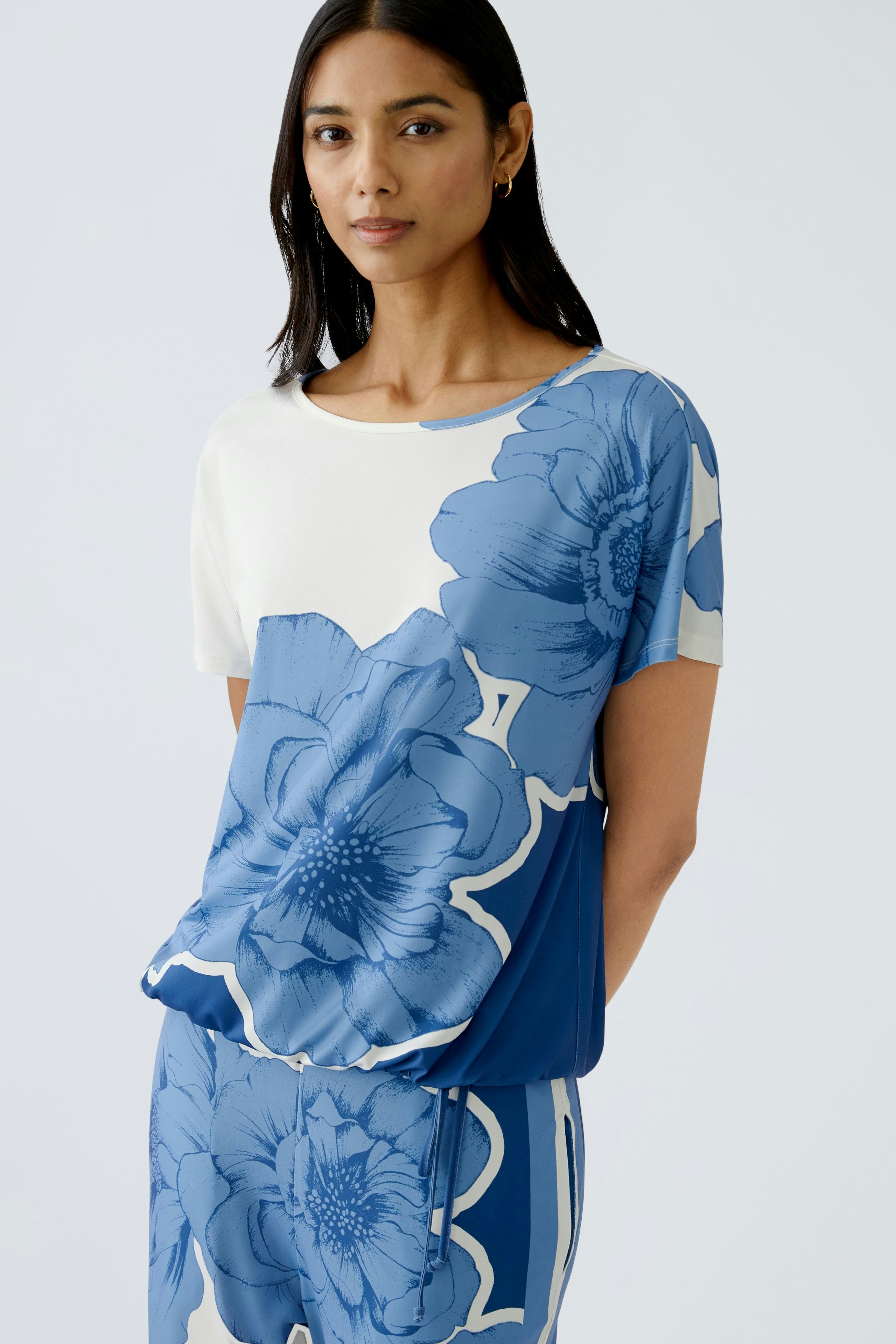 Stylish women's T-shirt featuring a vibrant blue floral design, perfect for casual wear.
