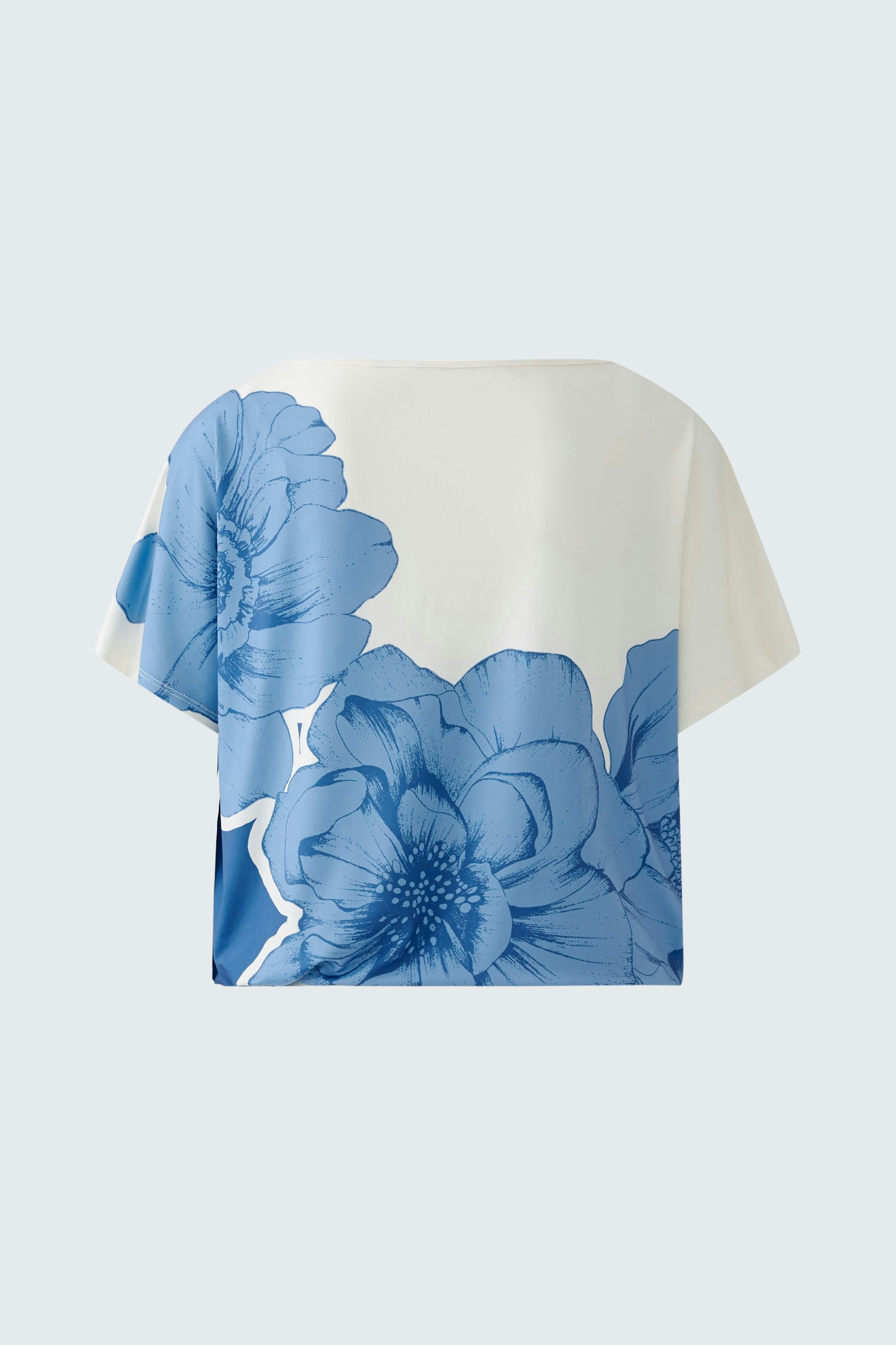 Stylish women's T-shirt featuring a vibrant blue floral design on a light background.