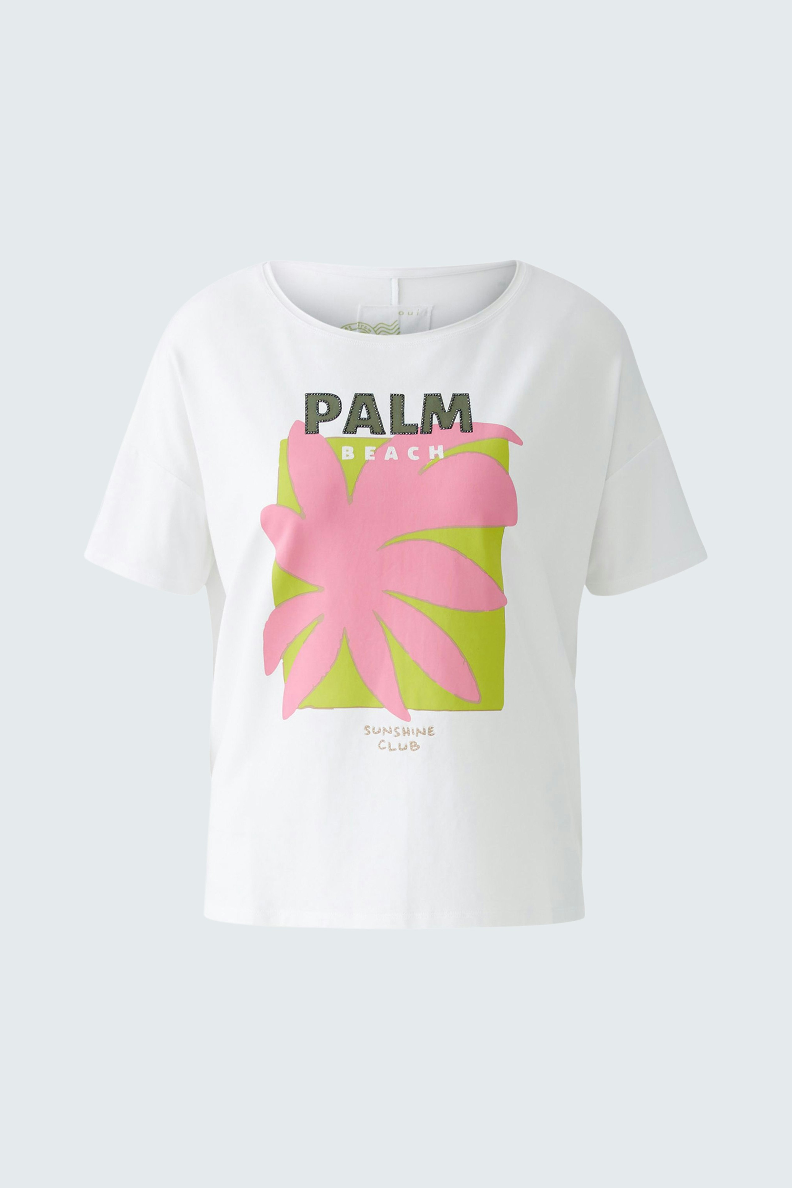 Stylish women's T-shirt: White top with vibrant palm print, perfect for casual summer outings.