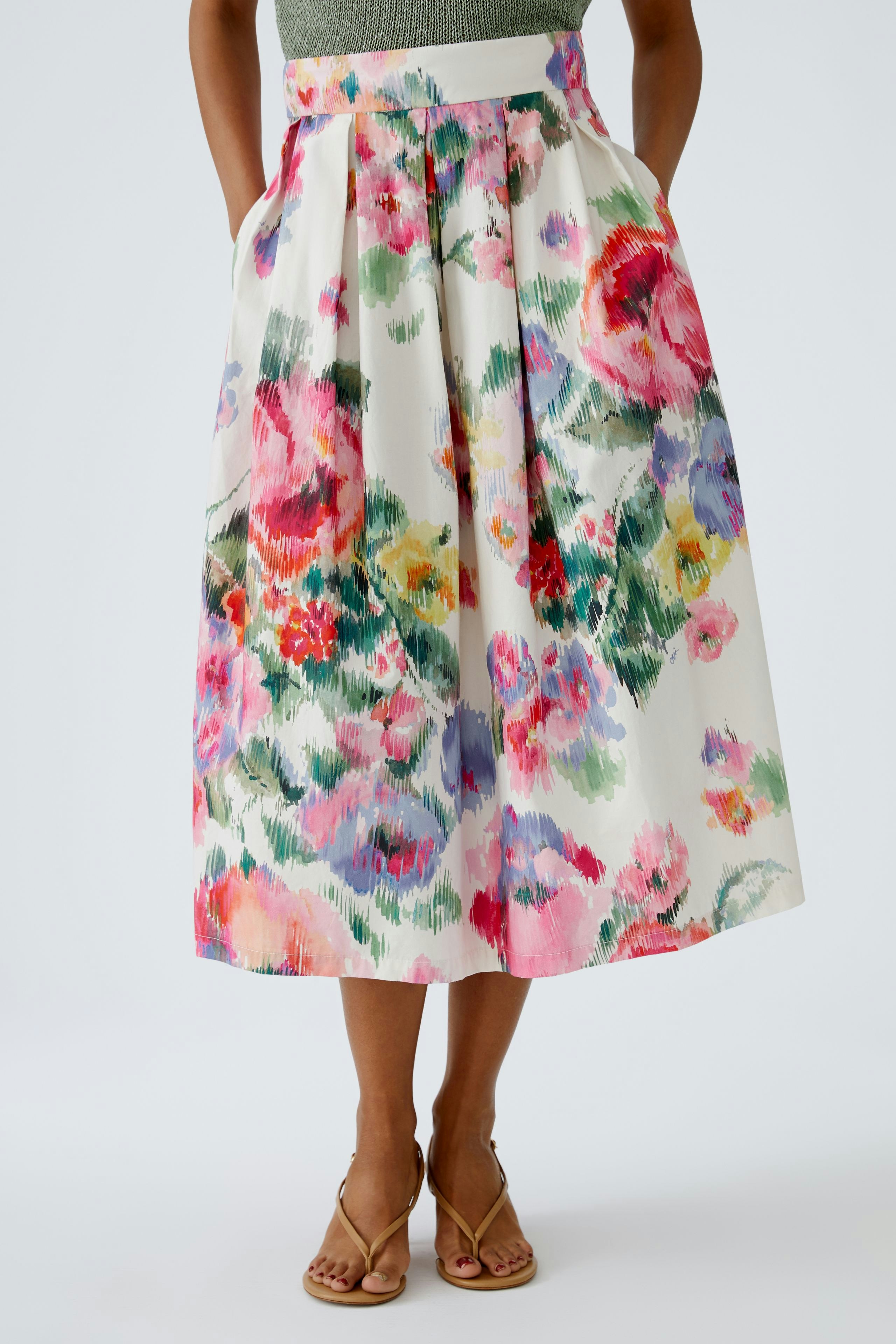 A-Linien-Rock: Frau trägt einen farbenfrohen Rock mit floralem Muster, ideal für den Sommer.