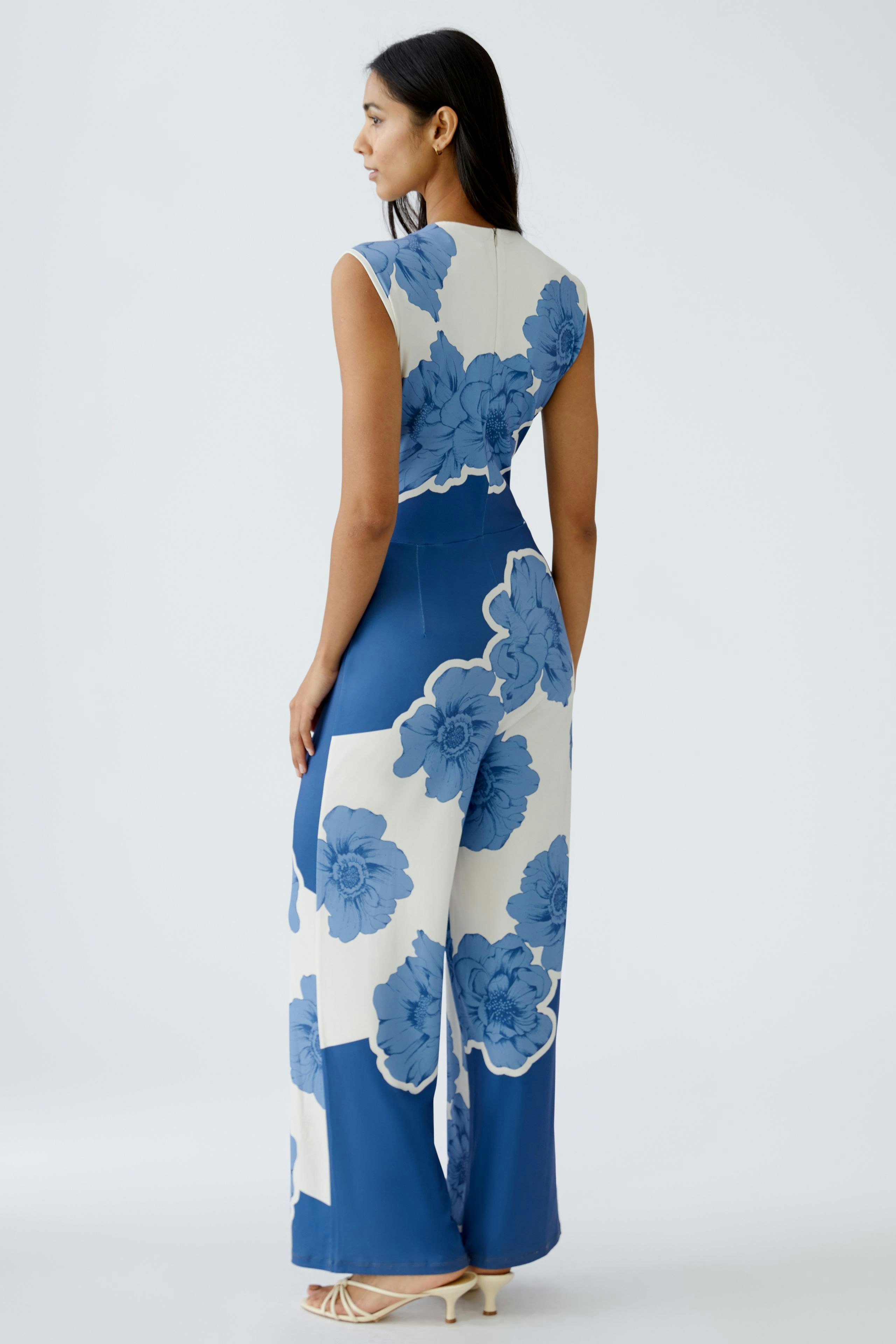 Elegant women's jumpsuit with floral design, showcasing a stylish back view.