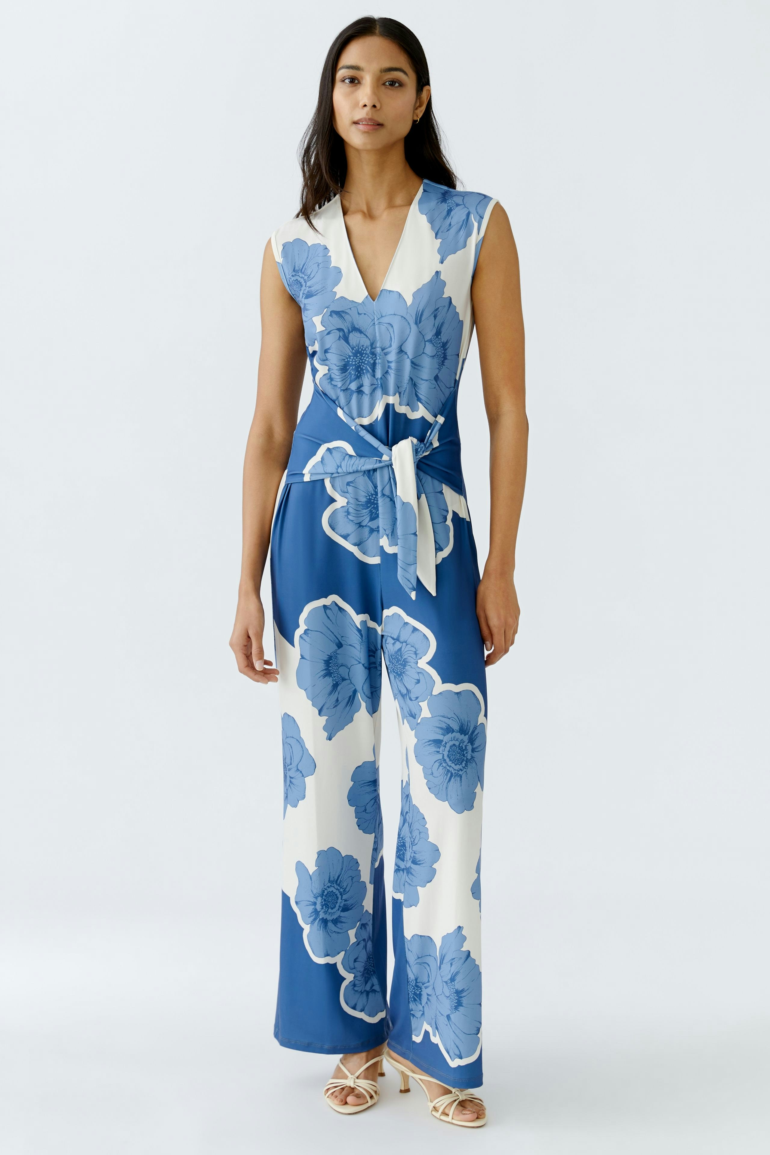 Elegant women's jumpsuit in blue and white floral design, perfect for any occasion.