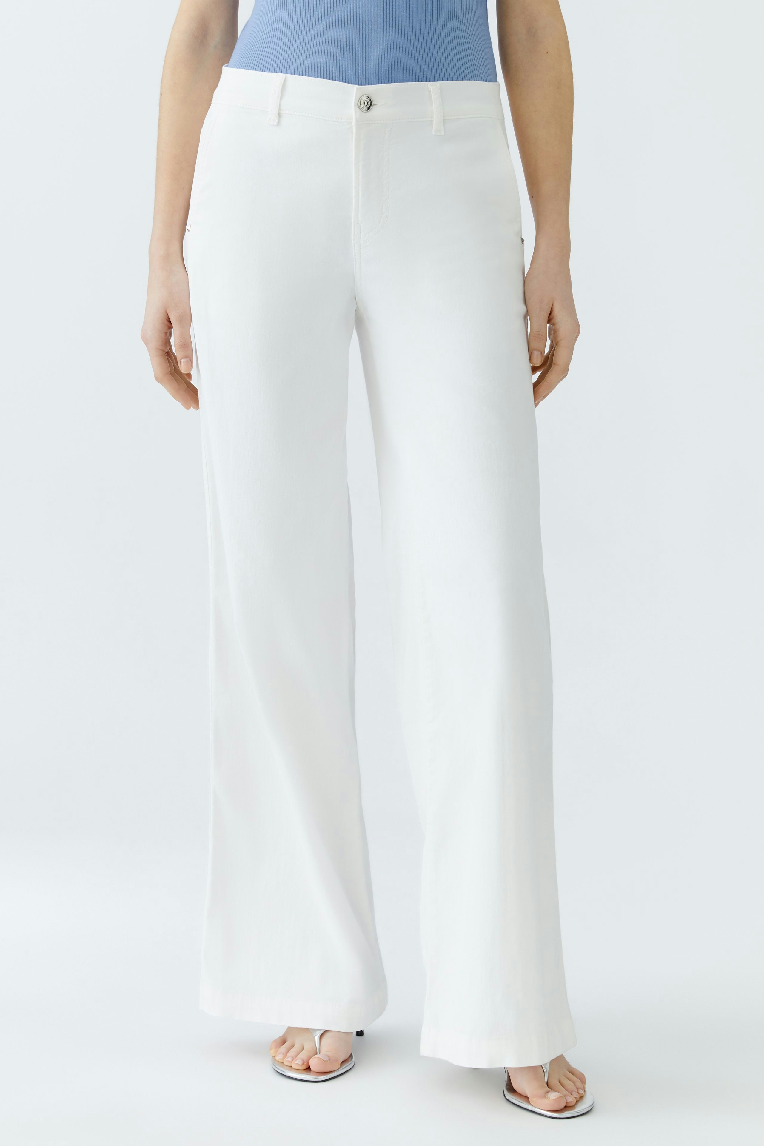 Casual women's trousers: A woman in white wide-leg pants stands confidently against a plain background.