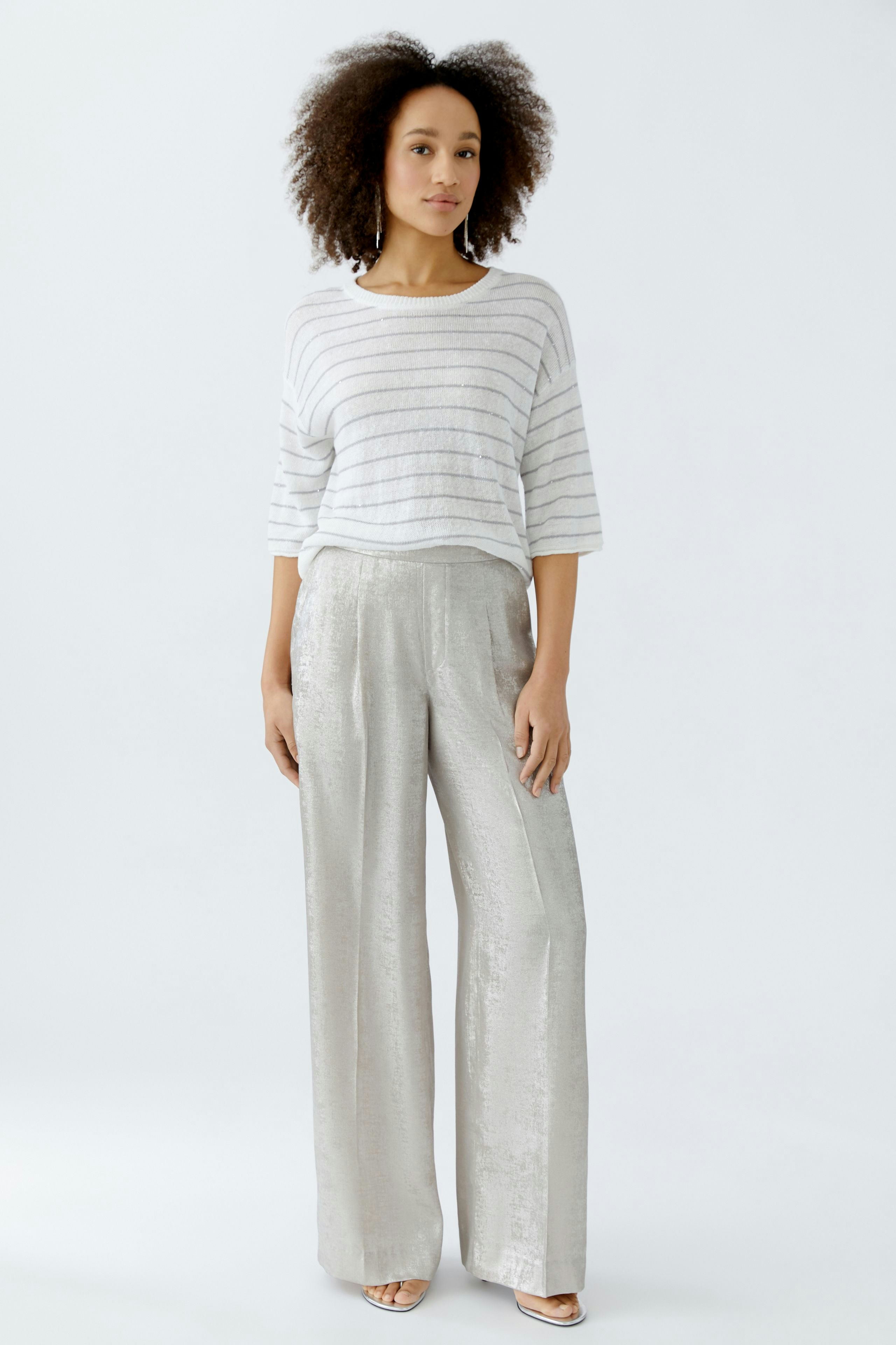 Casual women's Marlene trousers: A woman in shiny, wide-leg pants with a relaxed fit.