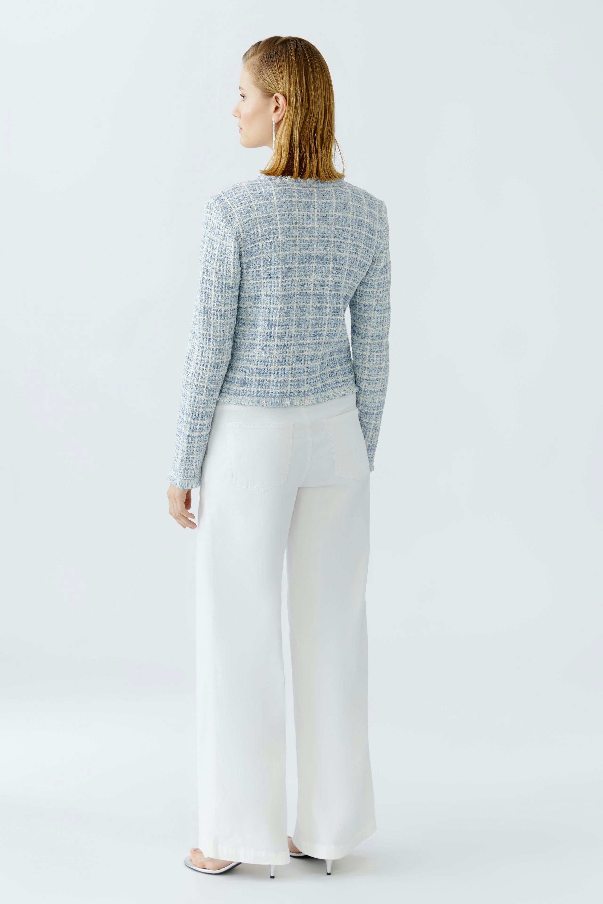 Casual women's cardigan: A woman in a light blue knitted cardigan with a textured pattern.