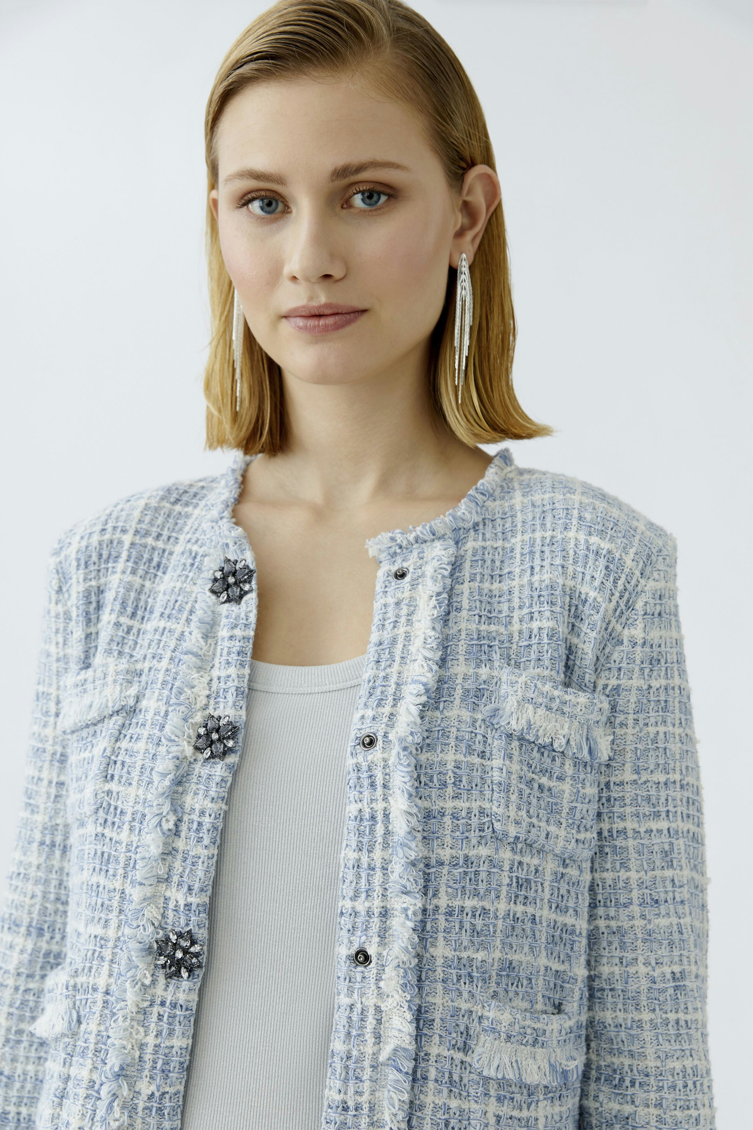 Casual women's cardigan: A woman in a light blue textured cardigan with buttons and a relaxed fit.