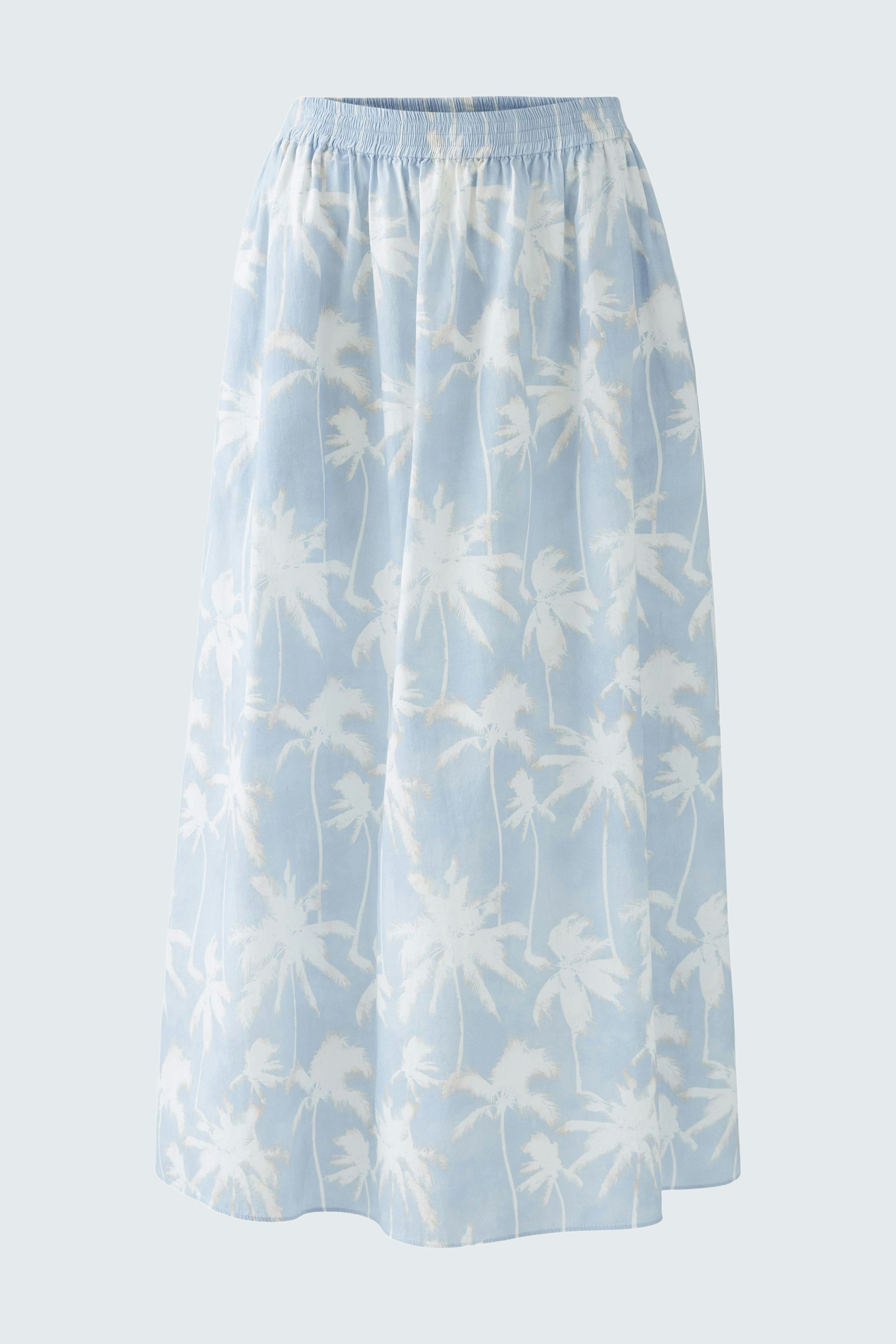 Light blue maxi skirt with palm tree print, featuring an elastic waistband.