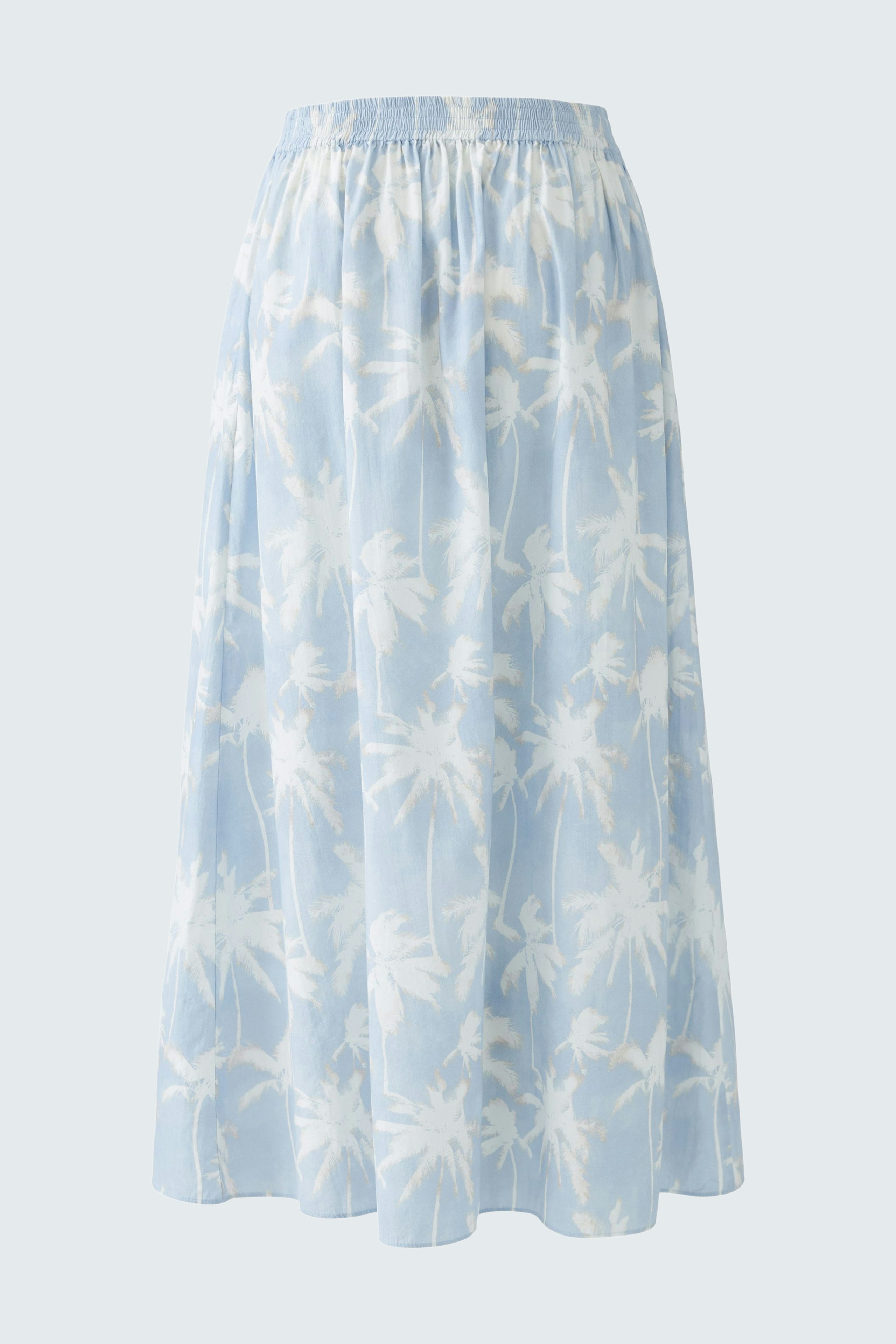 Light blue maxi skirt with a palm tree print, featuring an elastic waistband for comfort.