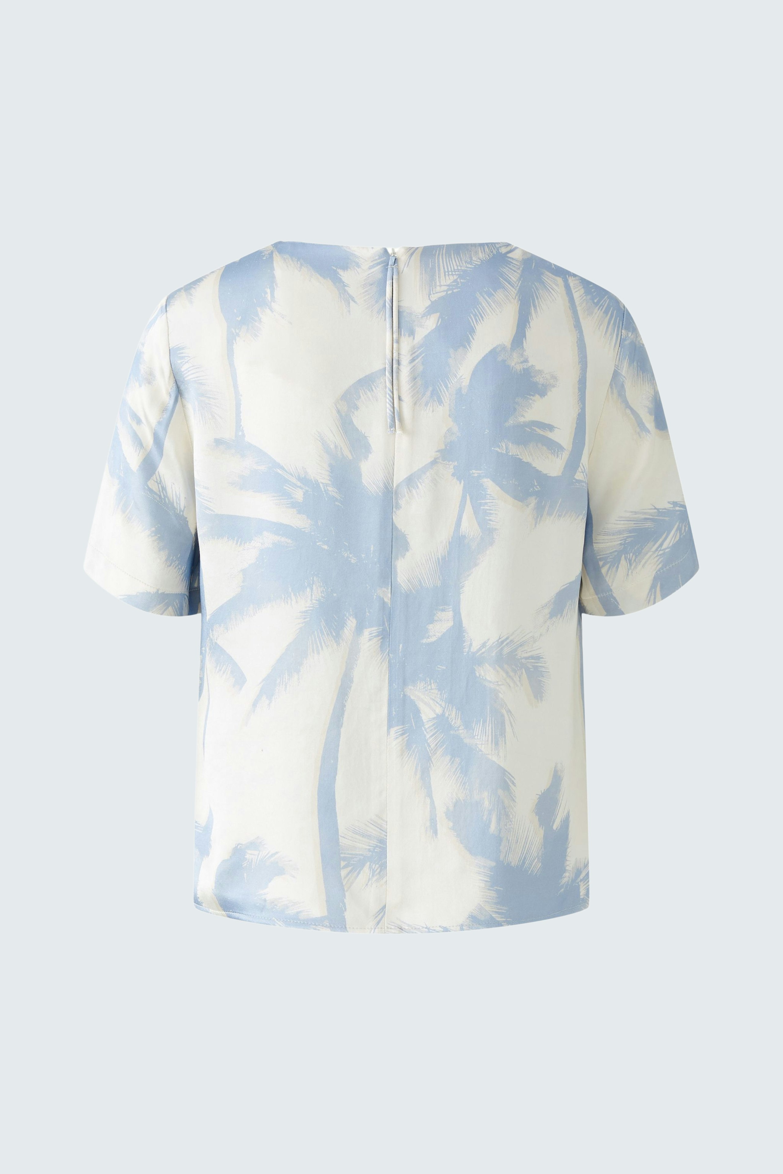 Casual women's blouse: Back view of a short-sleeve top with a light blue palm tree print.