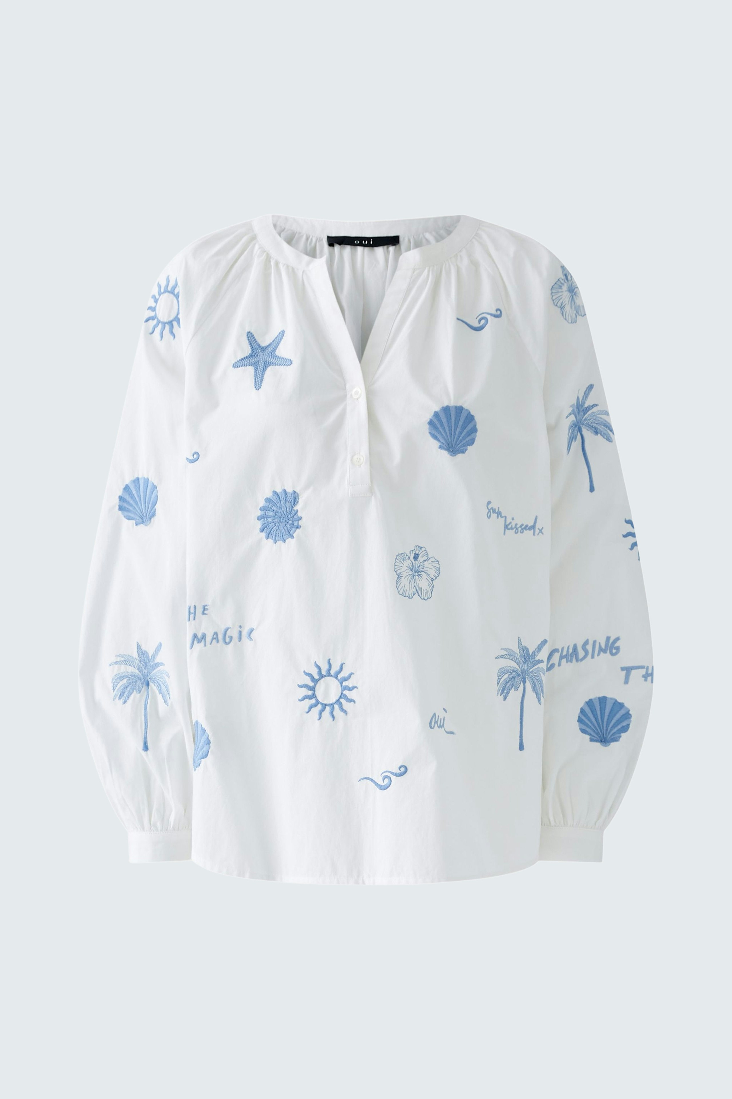 Lightweight women's tunic in white with blue beach-themed prints, featuring a relaxed fit and long sleeves.