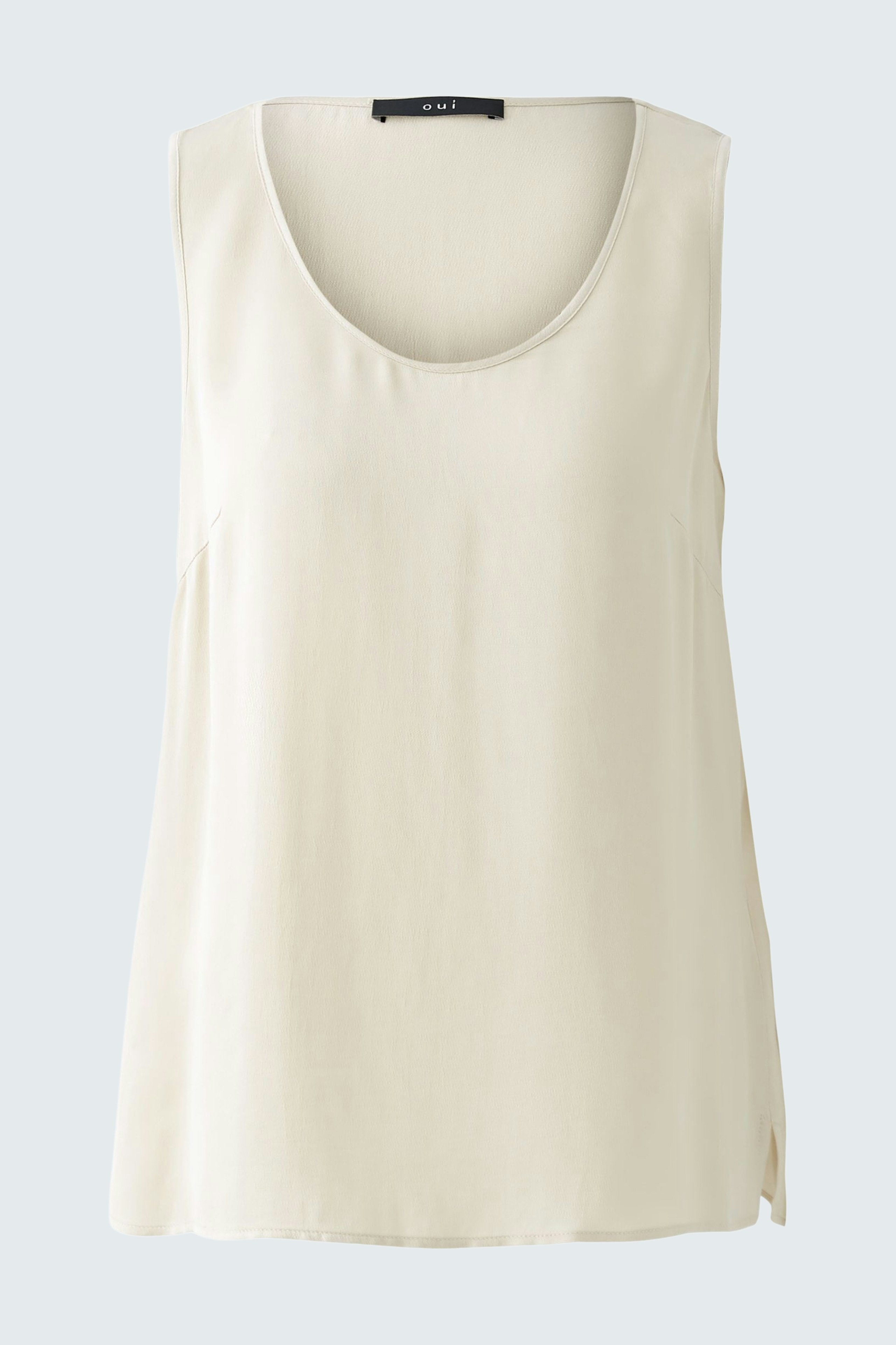 Casual women's top: A light cream sleeveless top with a round neckline, perfect for warm days.