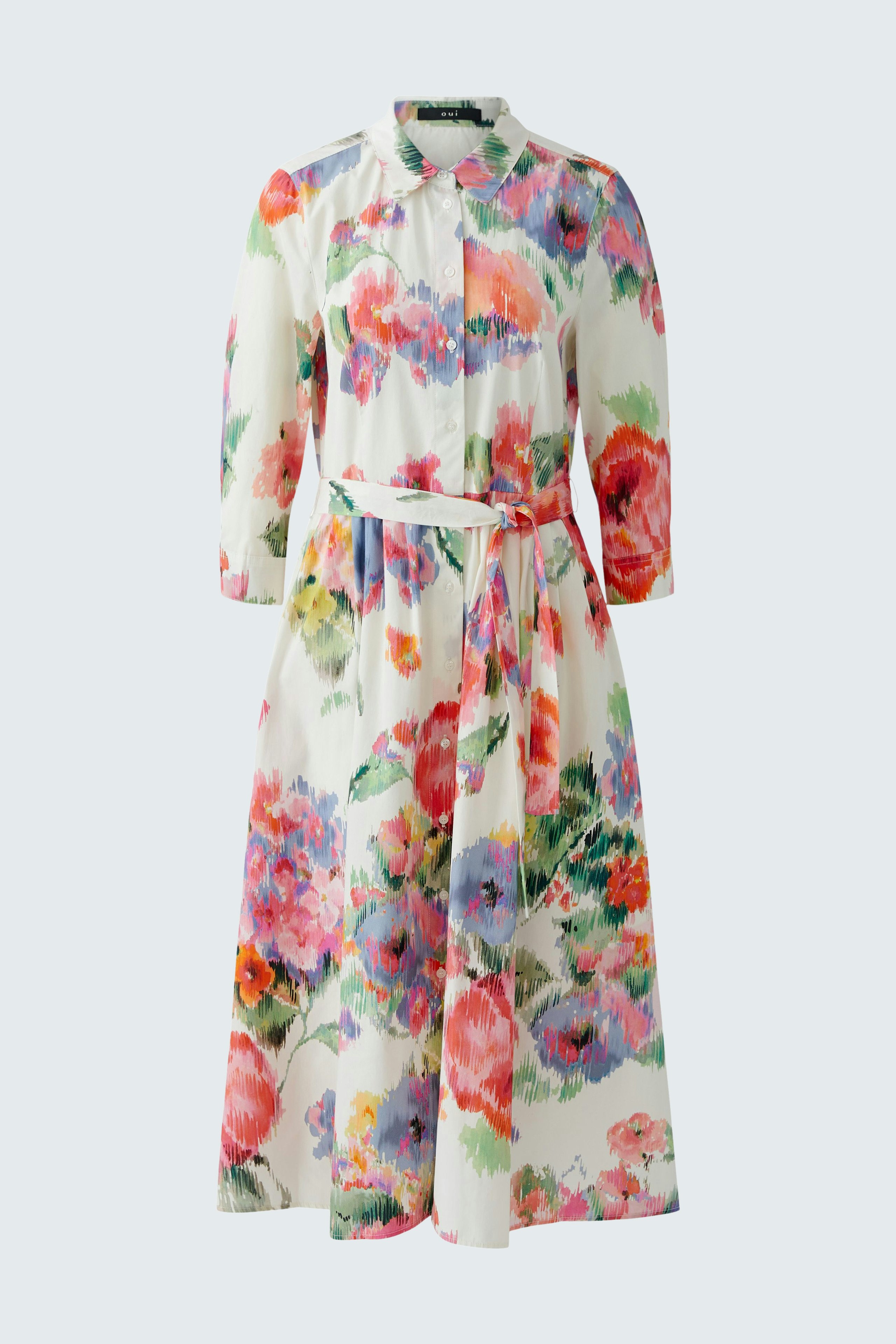 Floral mididress: A woman in a colorful dress with a tie waist and button-up collar.