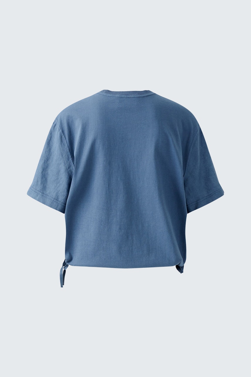 Casual women's blouse shirt in soft blue with a relaxed fit and tie detail at the hem.