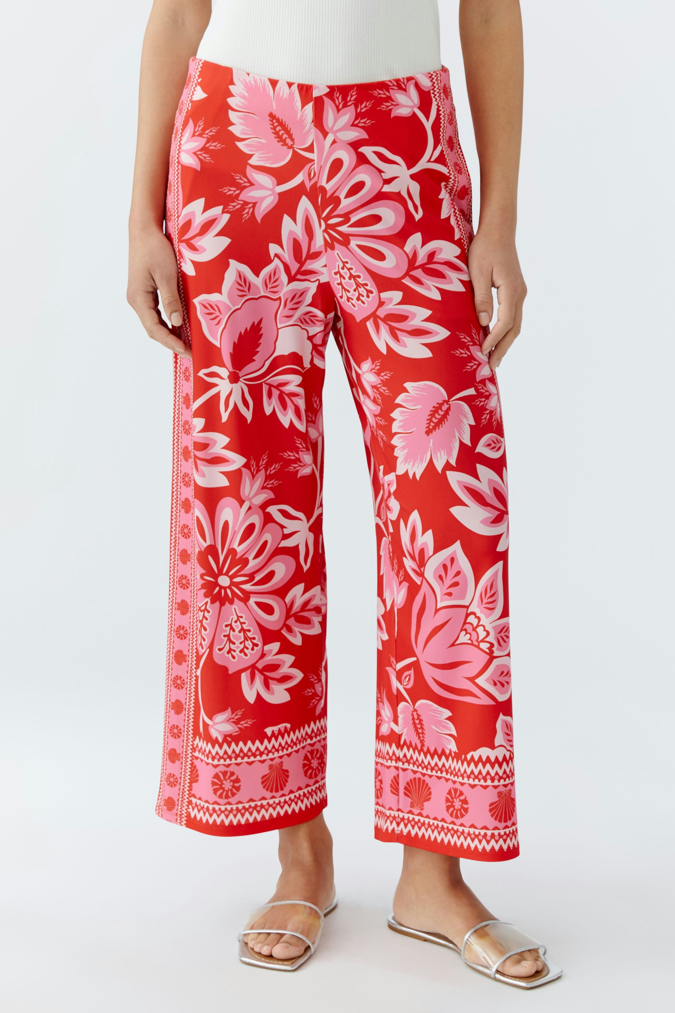Vibrant women's pants with floral print, featuring a relaxed fit and wide legs for comfort.
