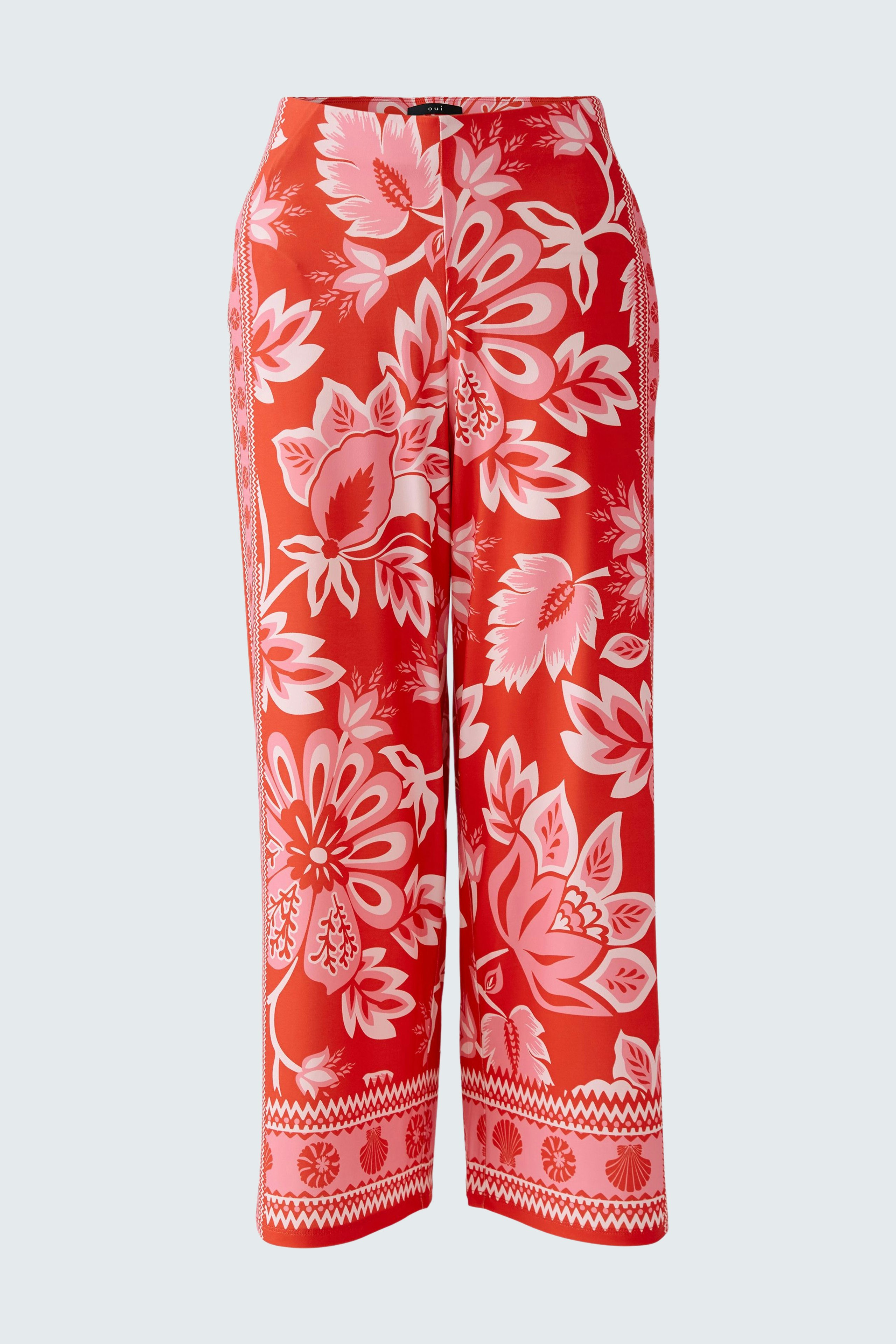 Vibrant women's trousers with a floral pattern in red and pink, perfect for casual wear.