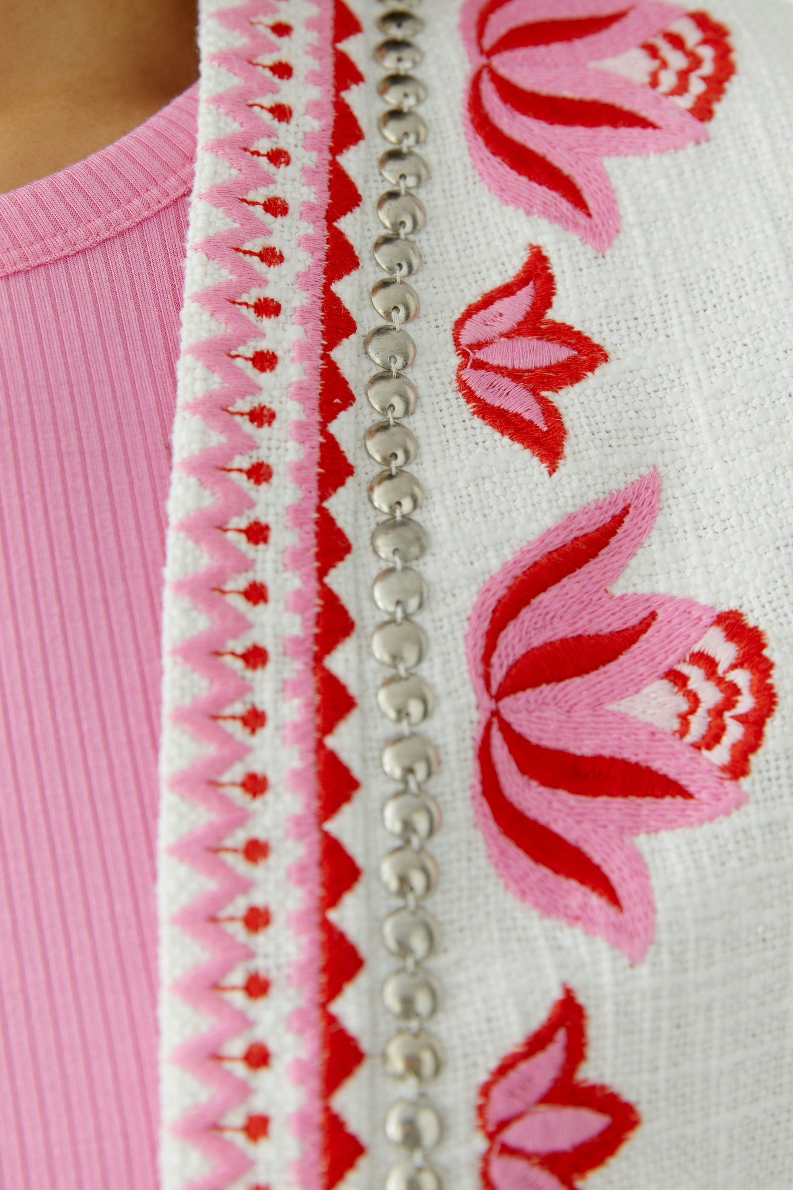 Colorful women's jacket with floral embroidery and decorative details, perfect for casual wear.