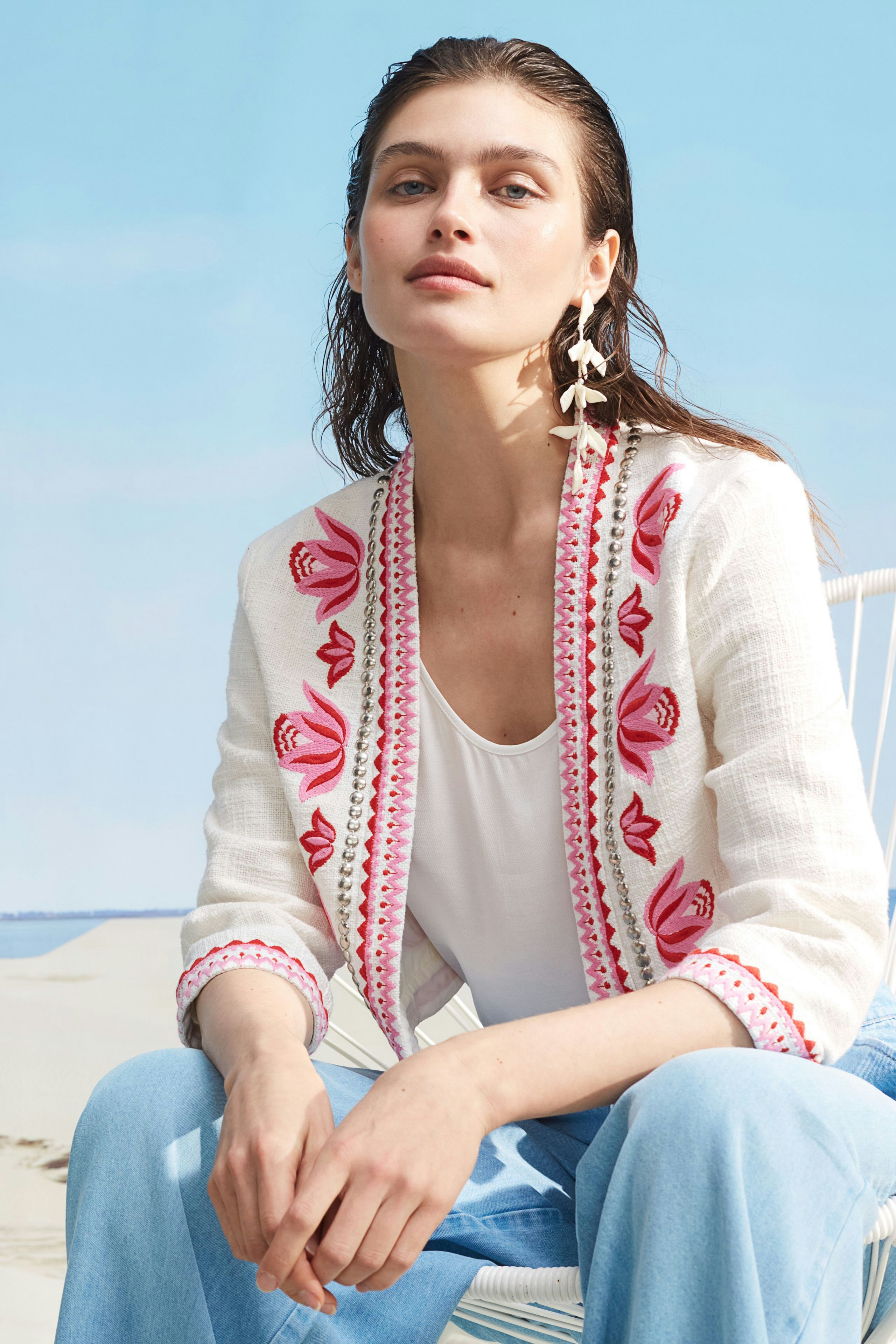 Stylish women's jacket with colorful embroidery, worn by a woman, perfect for casual outings.