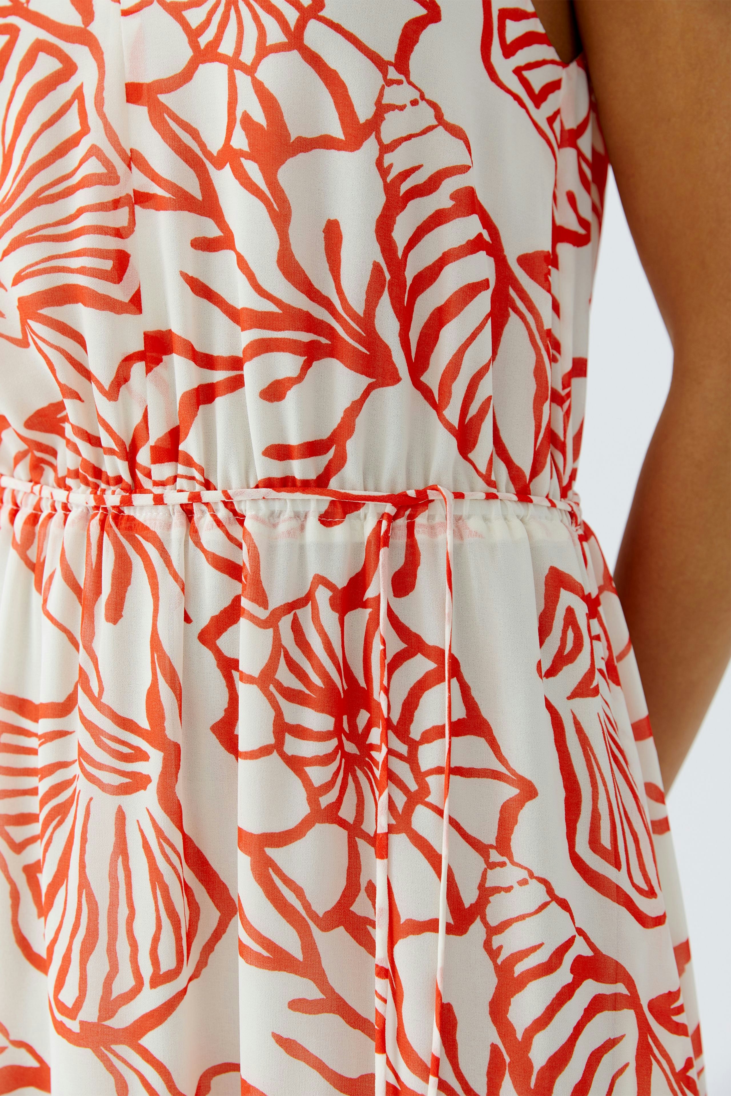 Maxikleid mit floralem Muster: Frau trägt ein luftiges Kleid mit buntem Design und elastischem Bund.