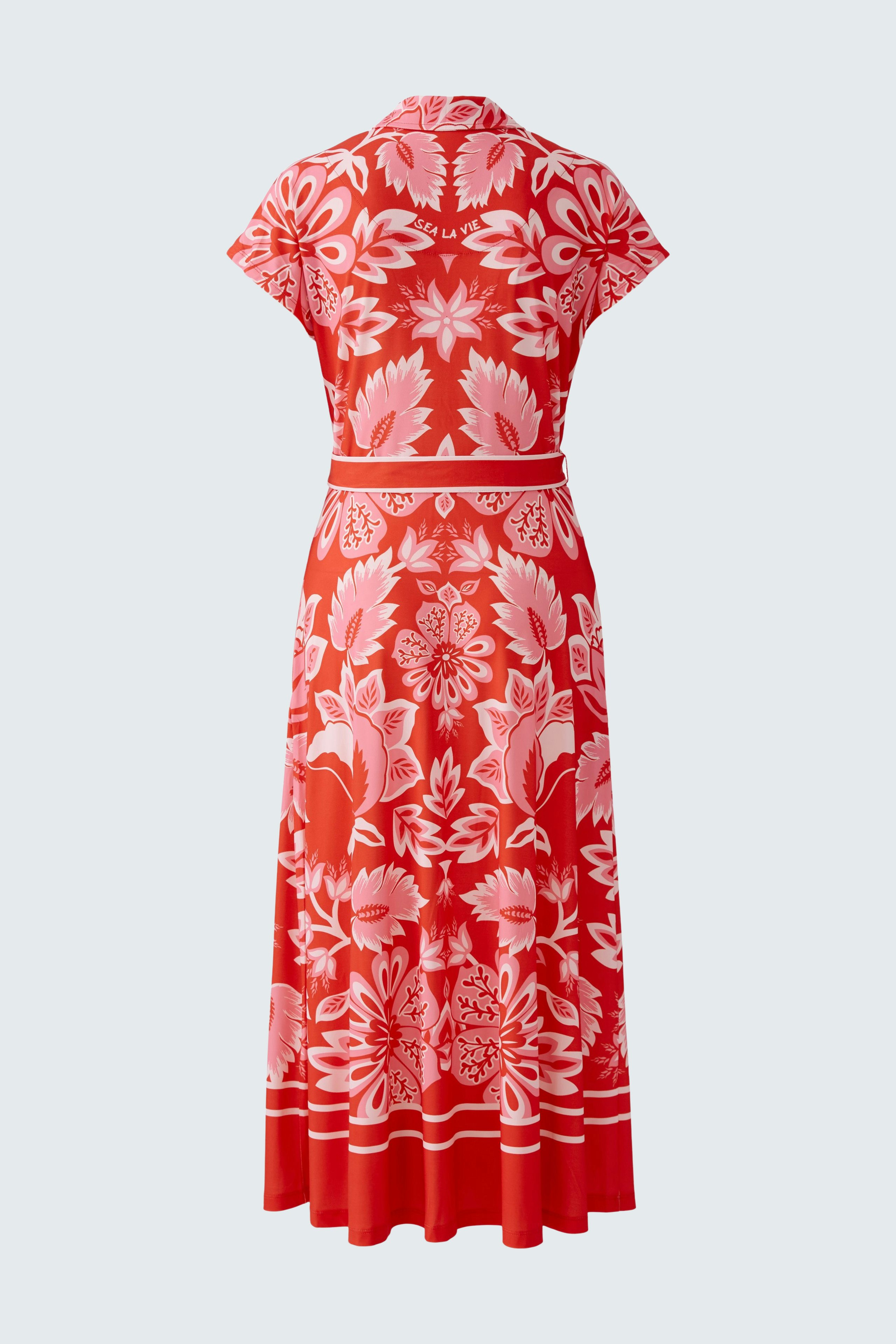 Floral shirt dress: A woman in a vibrant red dress with floral patterns, featuring short sleeves and a belt.