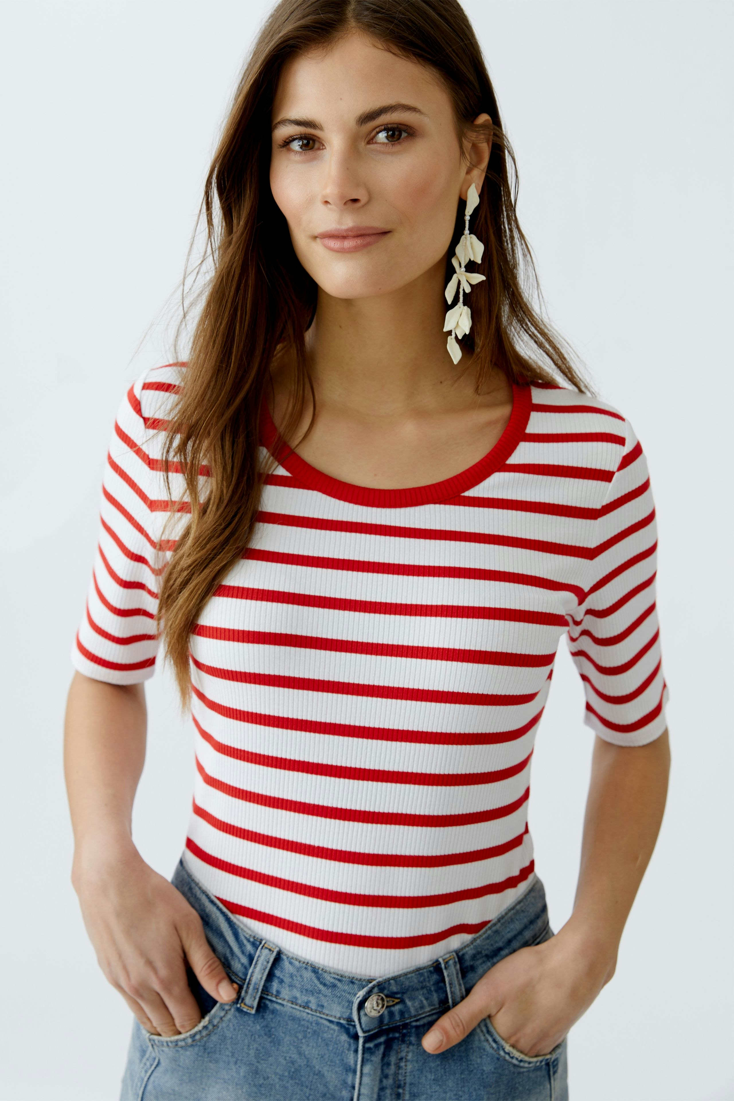 Casual women's T-shirt: Young woman in a red and white striped tee with a round neckline.