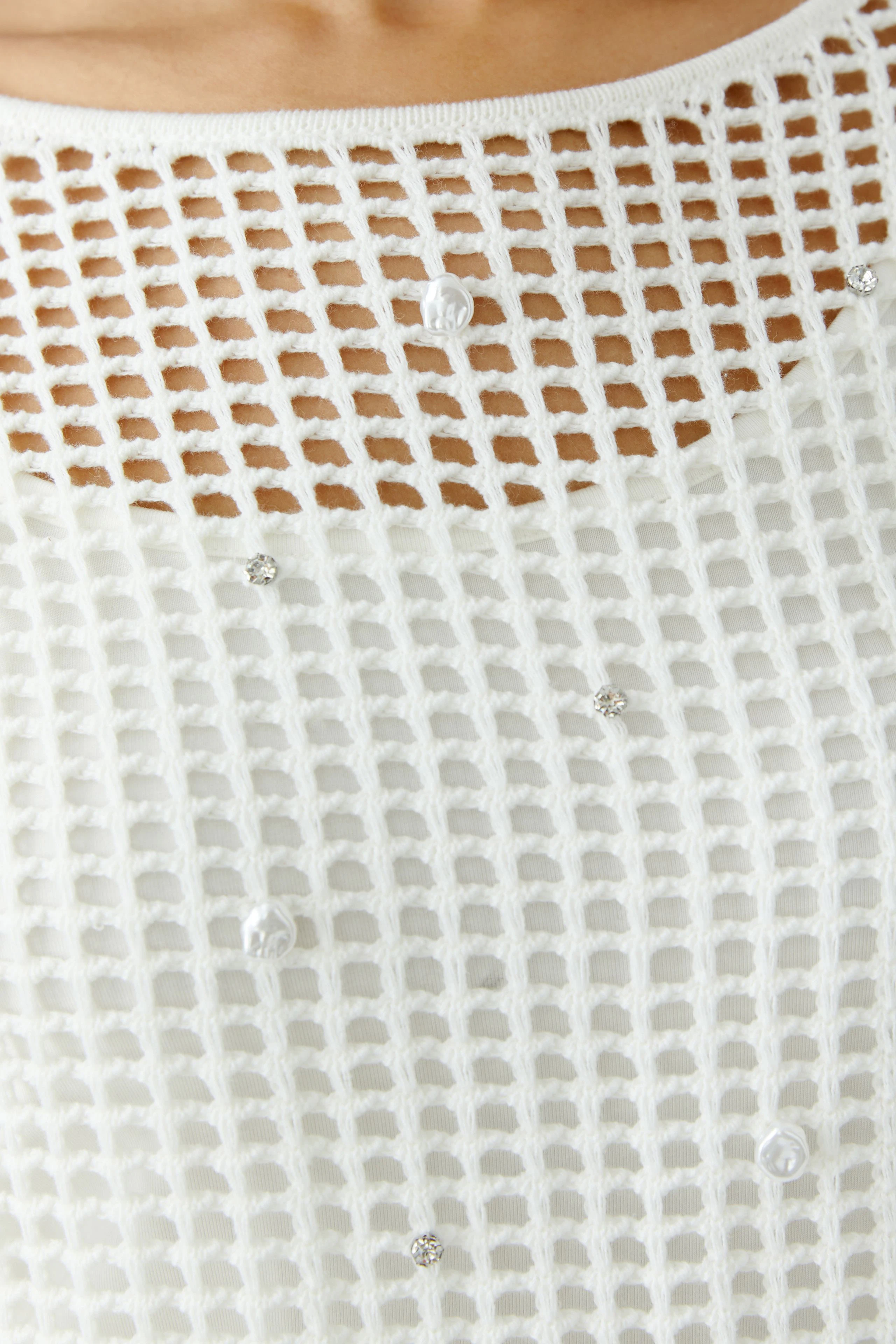 Lightweight women's pullover with a textured knit and decorative details, perfect for casual wear.