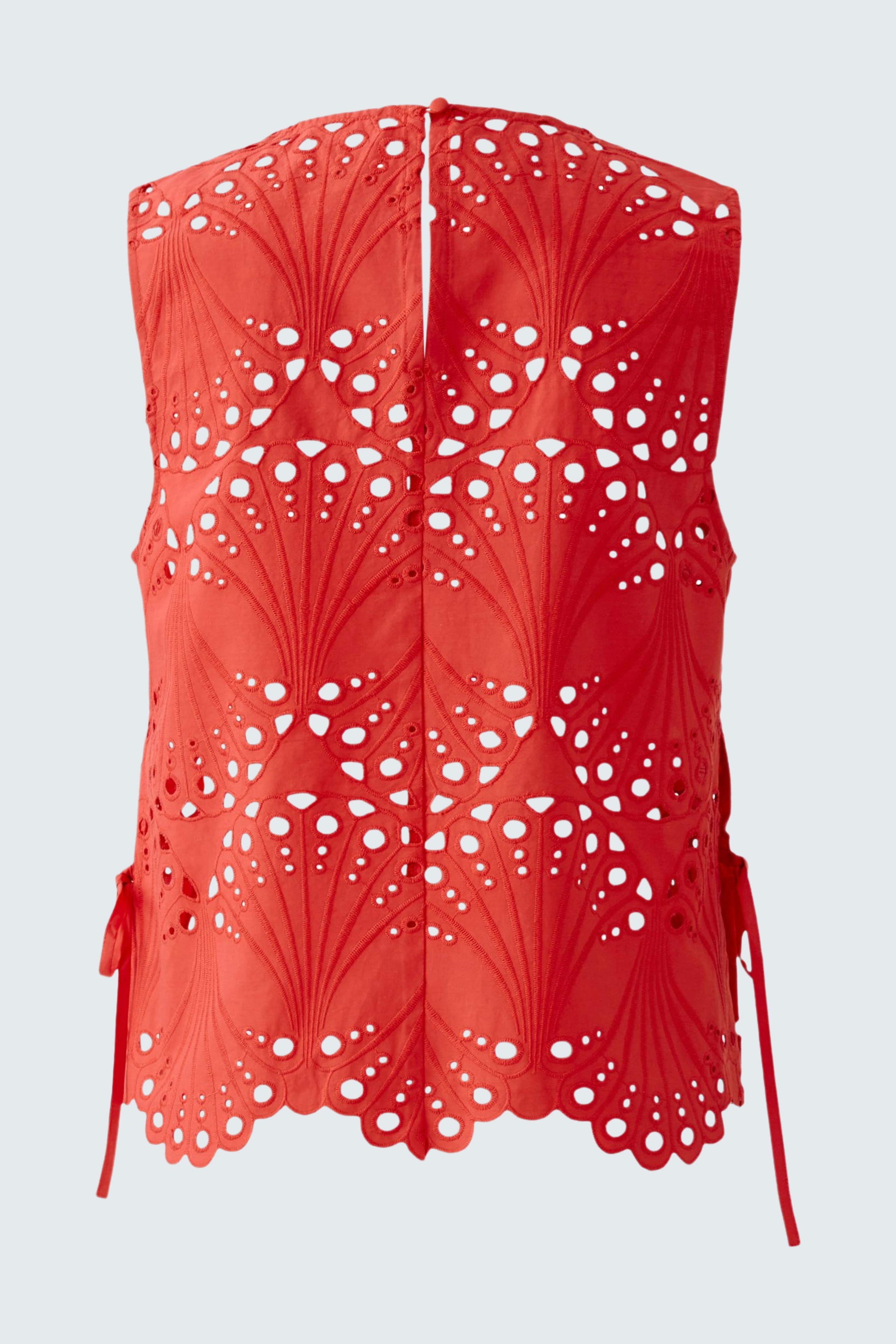 Stylish women's top: Bright red strapless top with intricate cut-out design and ties at the sides.