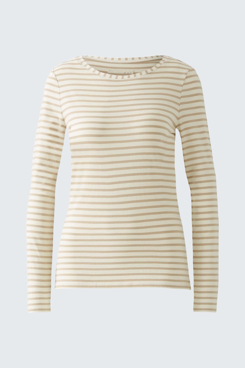 Stylish long-sleeve shirt: A woman in a cream striped pullover, perfect for casual wear.