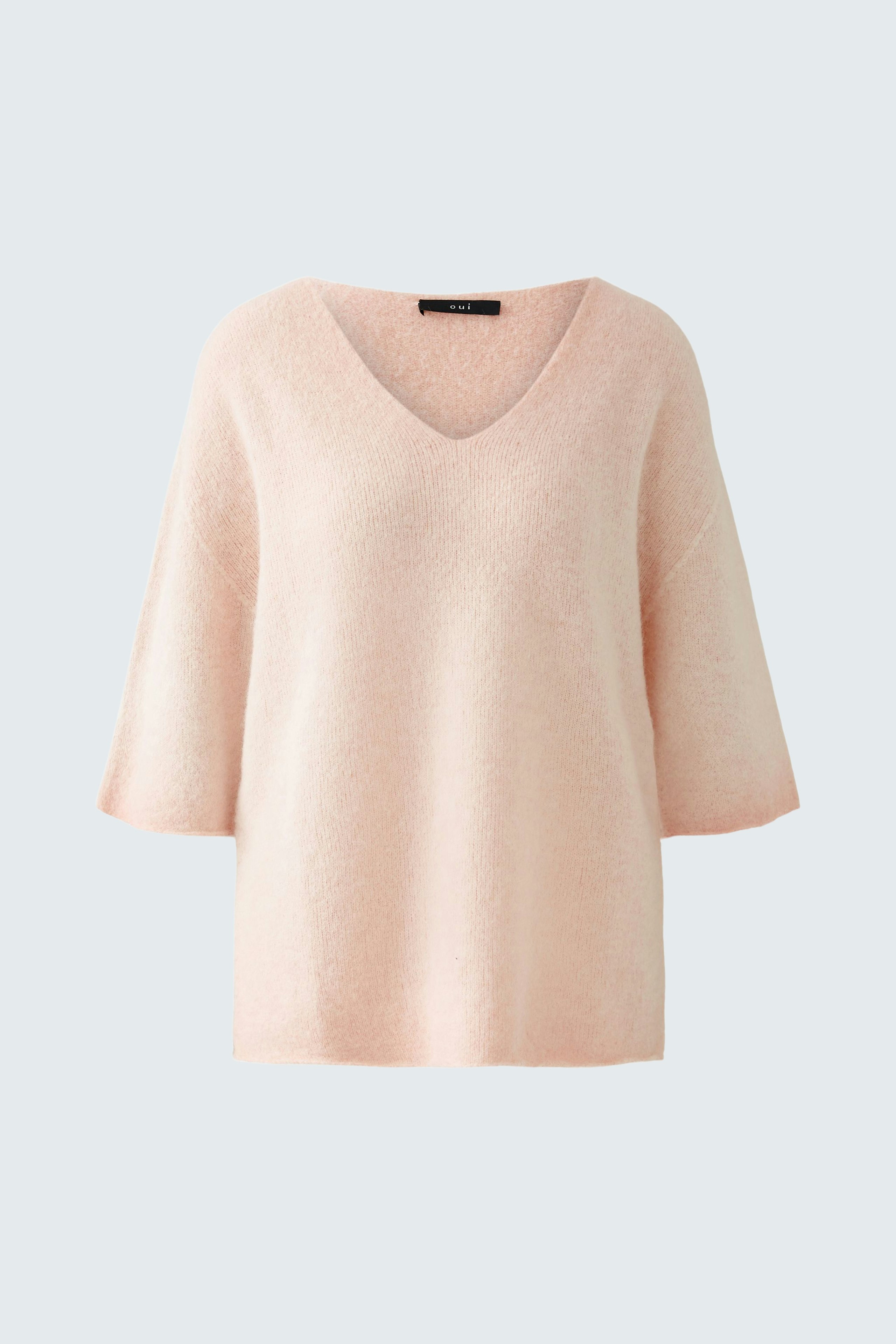 Soft pink pullover with a V-neck and wide sleeves, perfect for a casual yet stylish look.