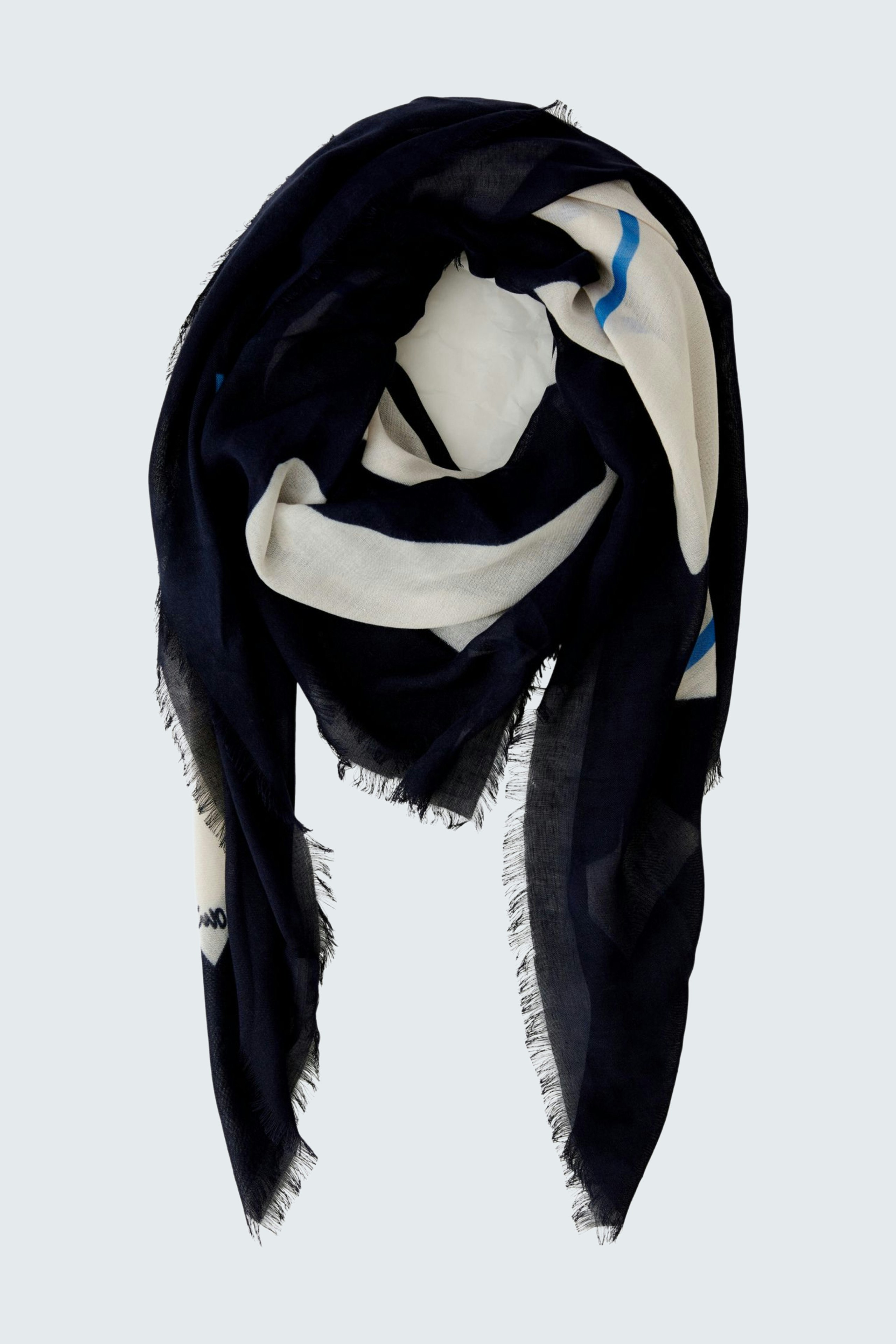 Stylish scarf: A navy and white patterned scarf elegantly draped, perfect for any outfit.