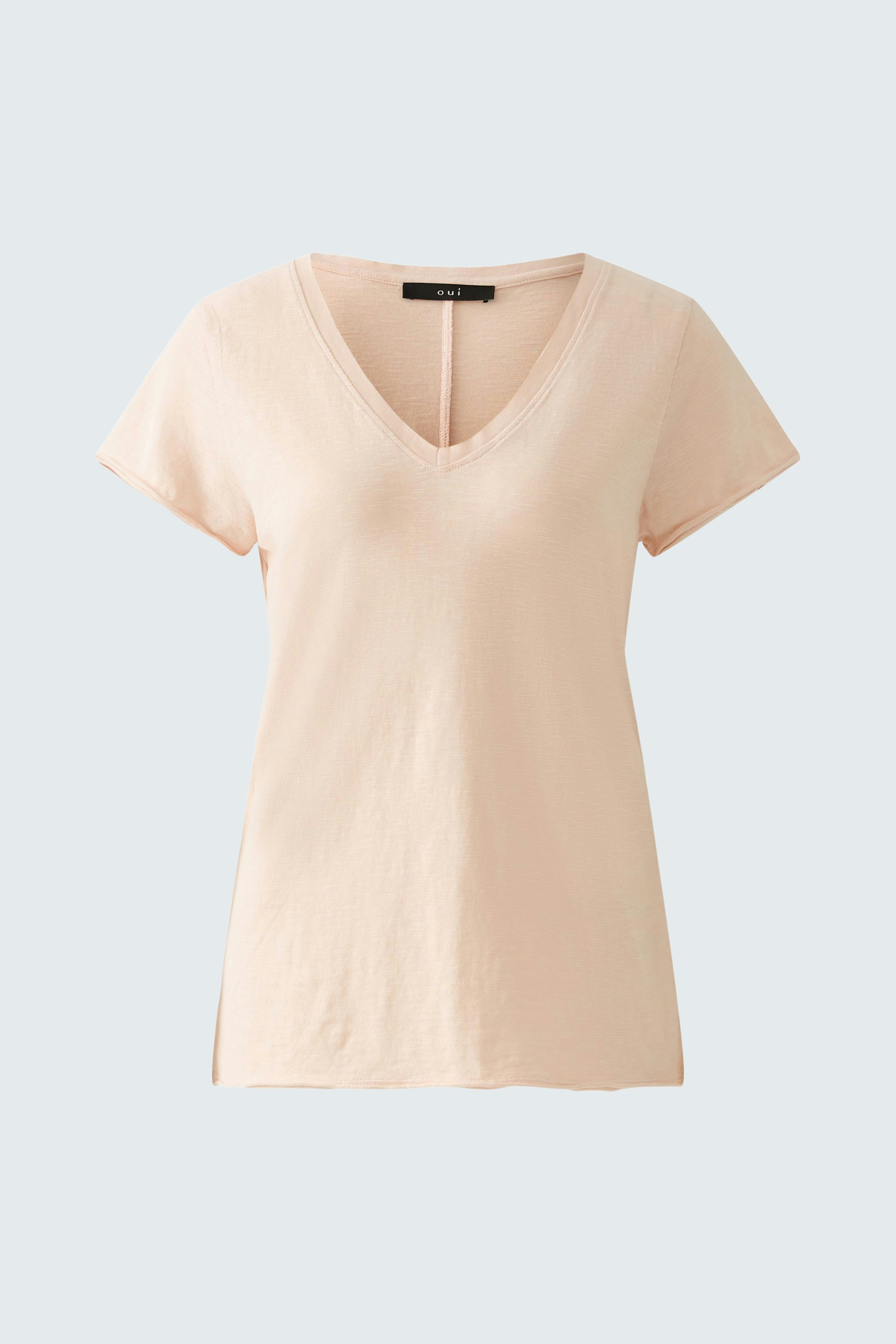 Stylish women's T-shirt in soft peach color with a flattering V-neck and short sleeves.
