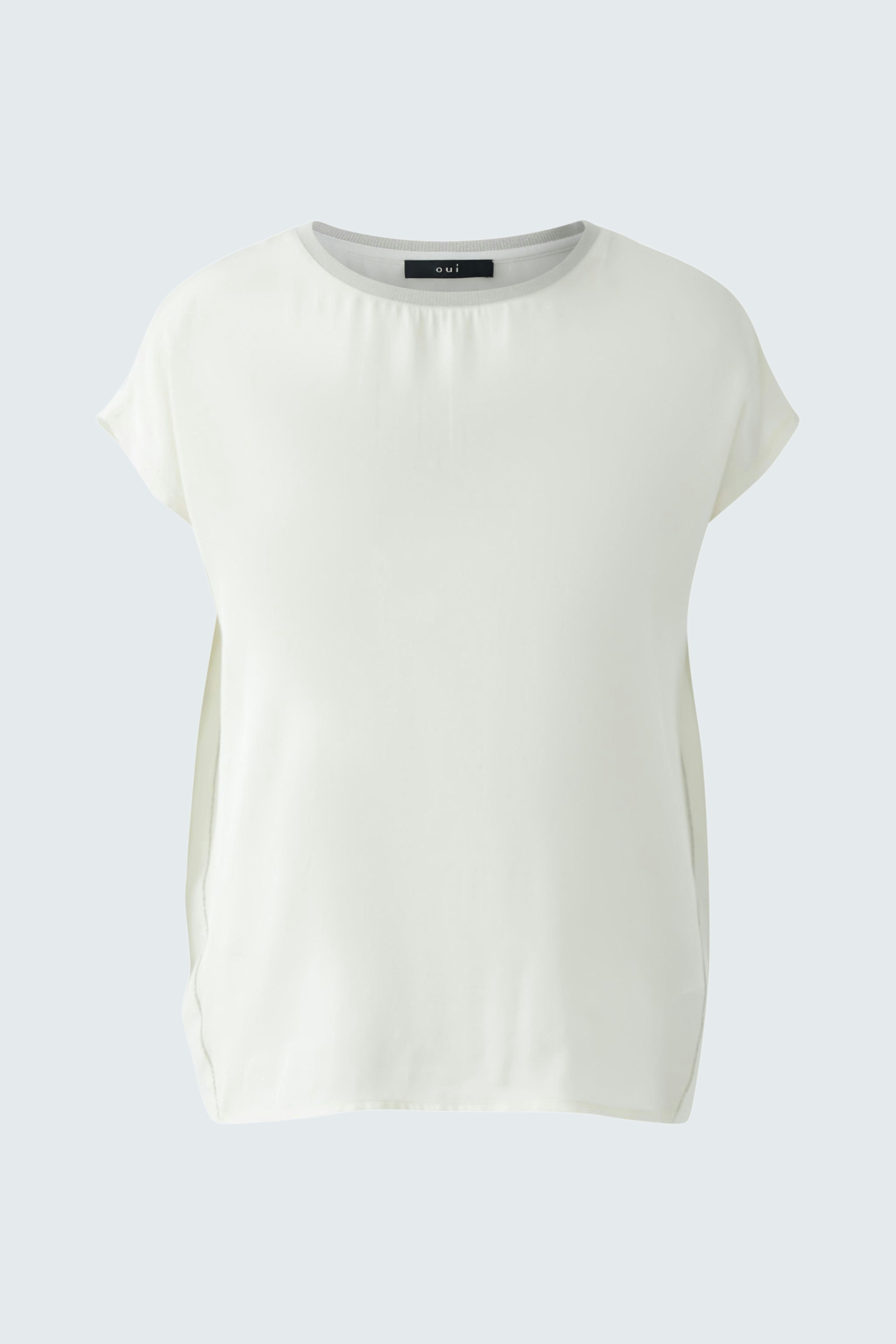 Elegant women's blouse shirt in soft white fabric, perfect for casual or formal occasions.