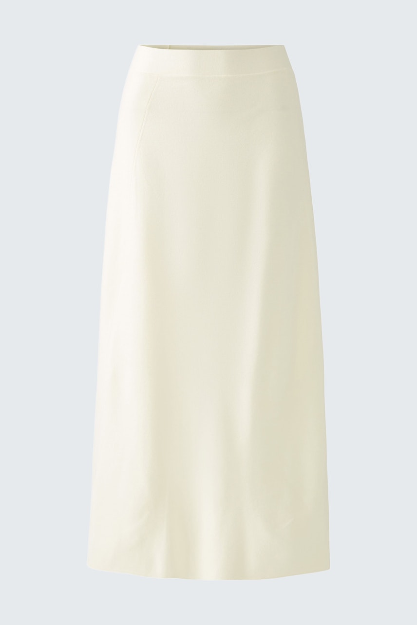Elegant women's knitted skirt in soft cream color, perfect for versatile styling.