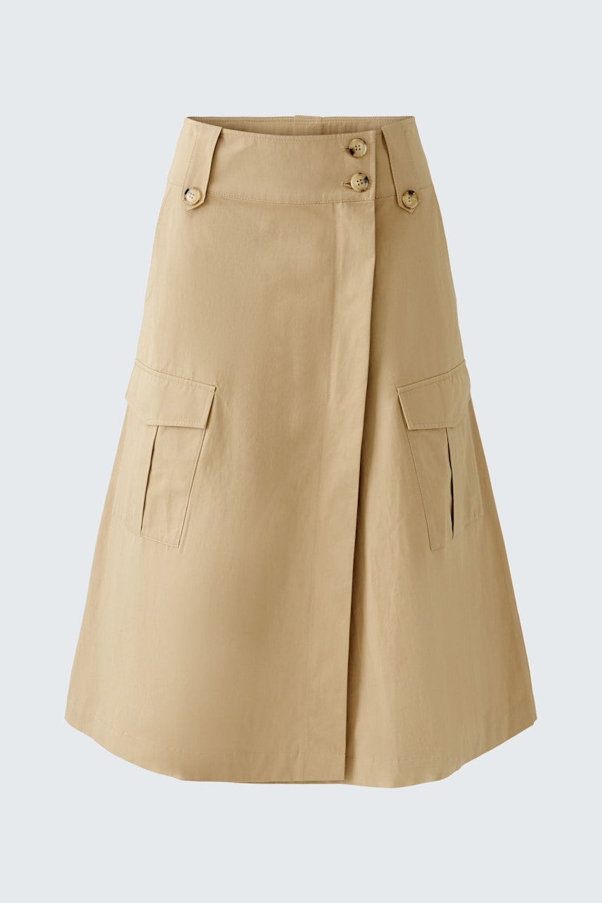 Stylish women's wrap skirt in beige with button details and practical pockets.