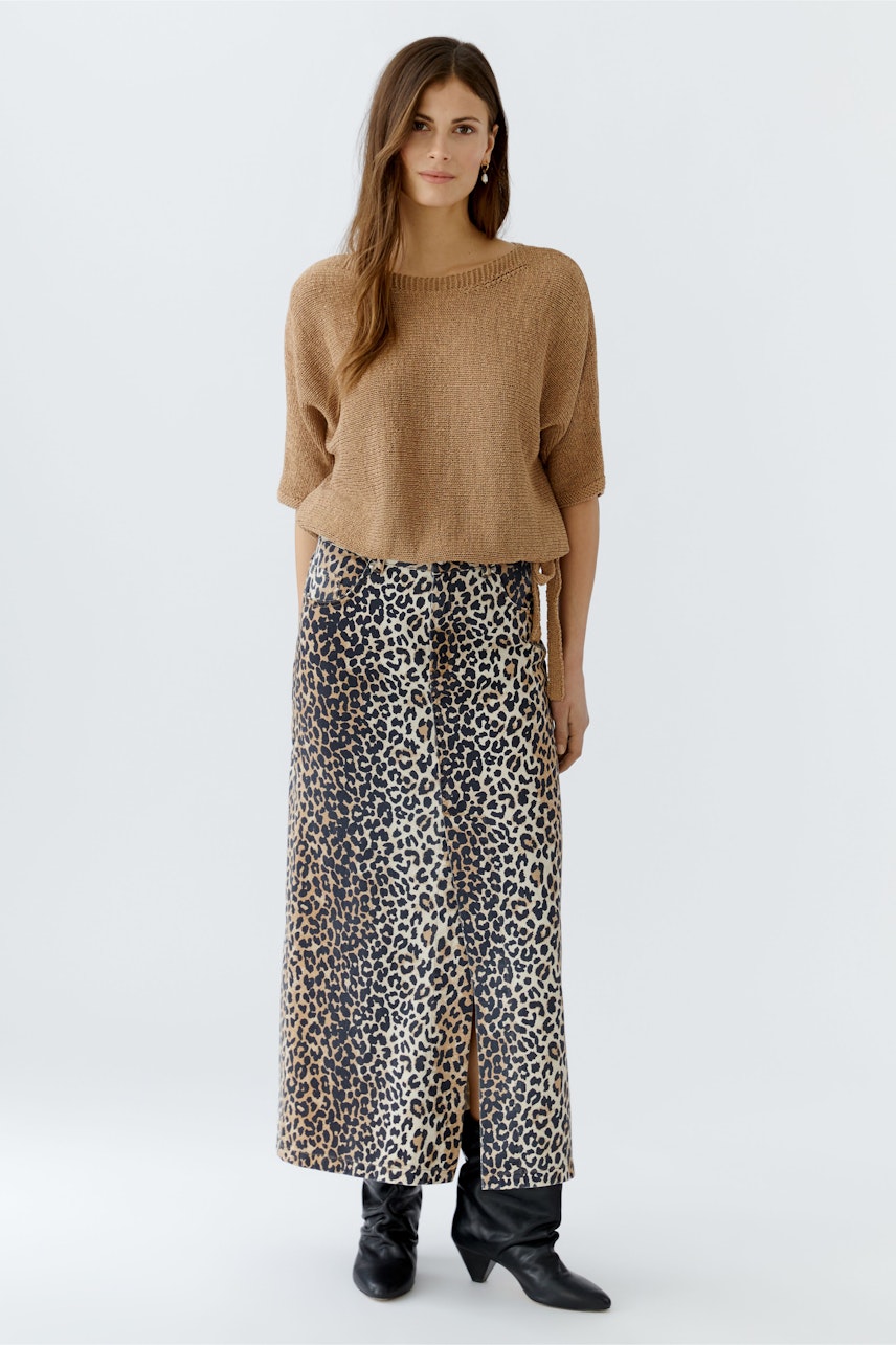 Damen-Pullover: Frau in braunem, lässigem Strickpullover mit weitem Schnitt und gemustertem Rock.