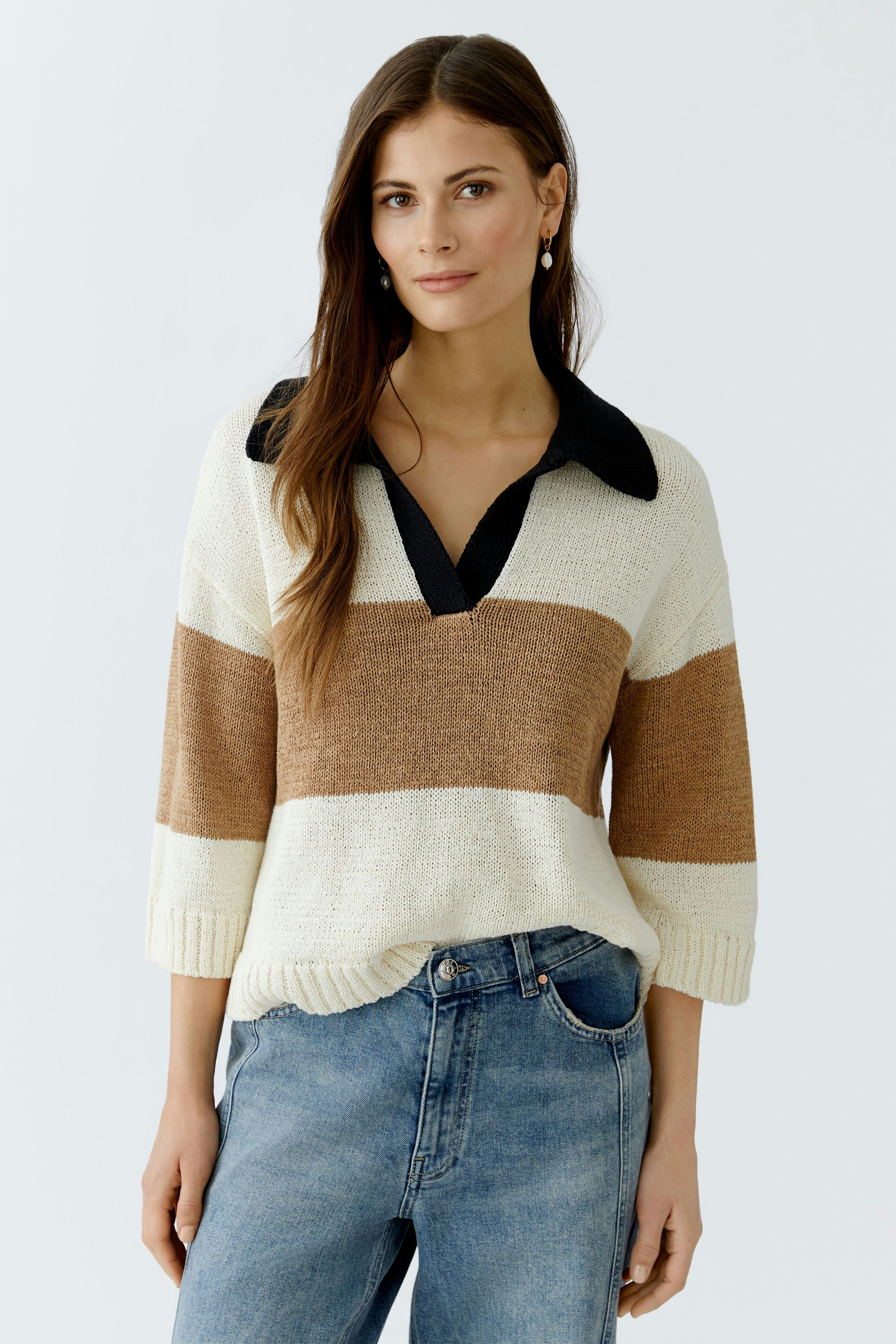 Casual women's pullover: Young woman in a striped pullover with a collar and relaxed fit.