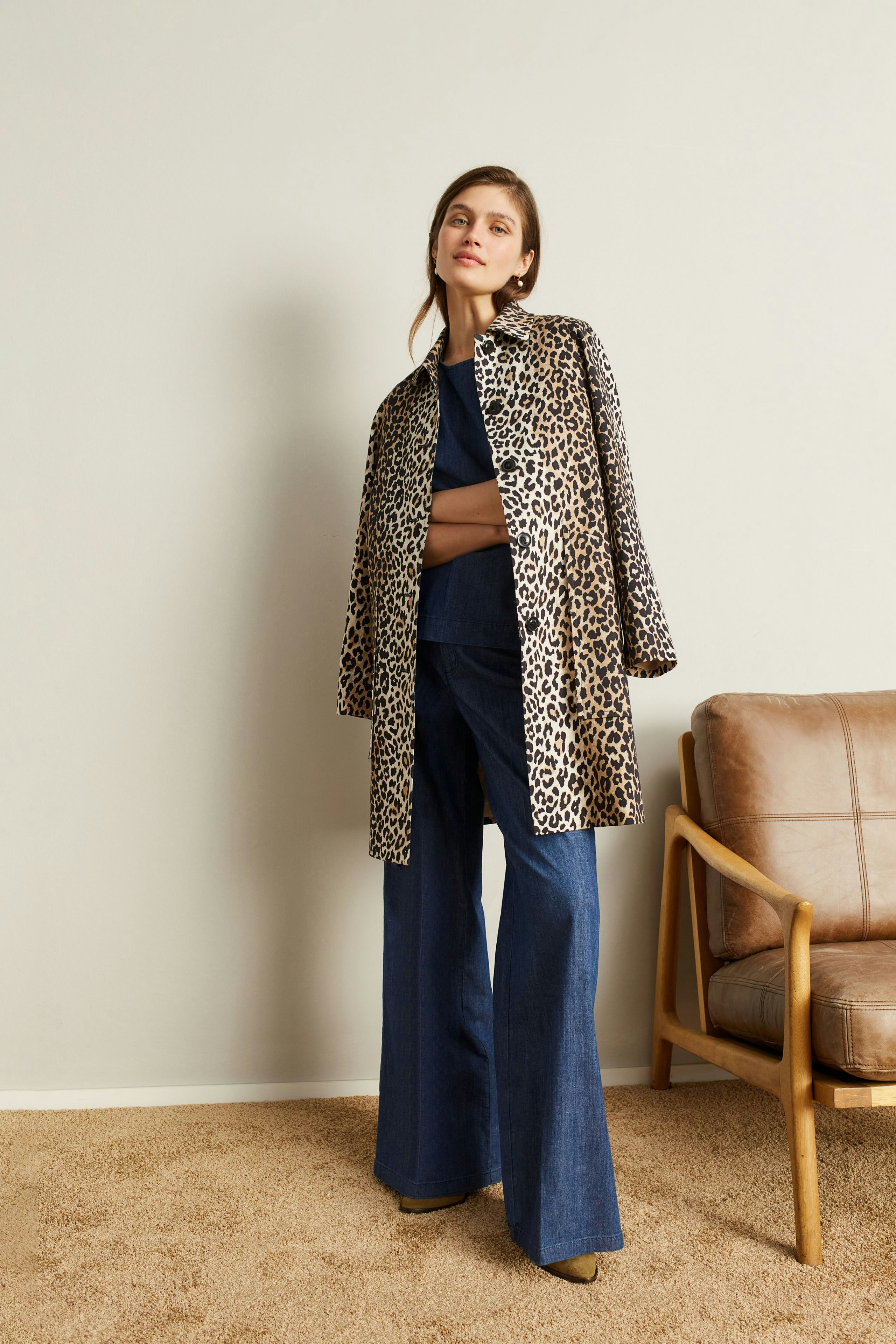 Stylish women's pants: A woman in wide-leg denim pants paired with a leopard print coat.