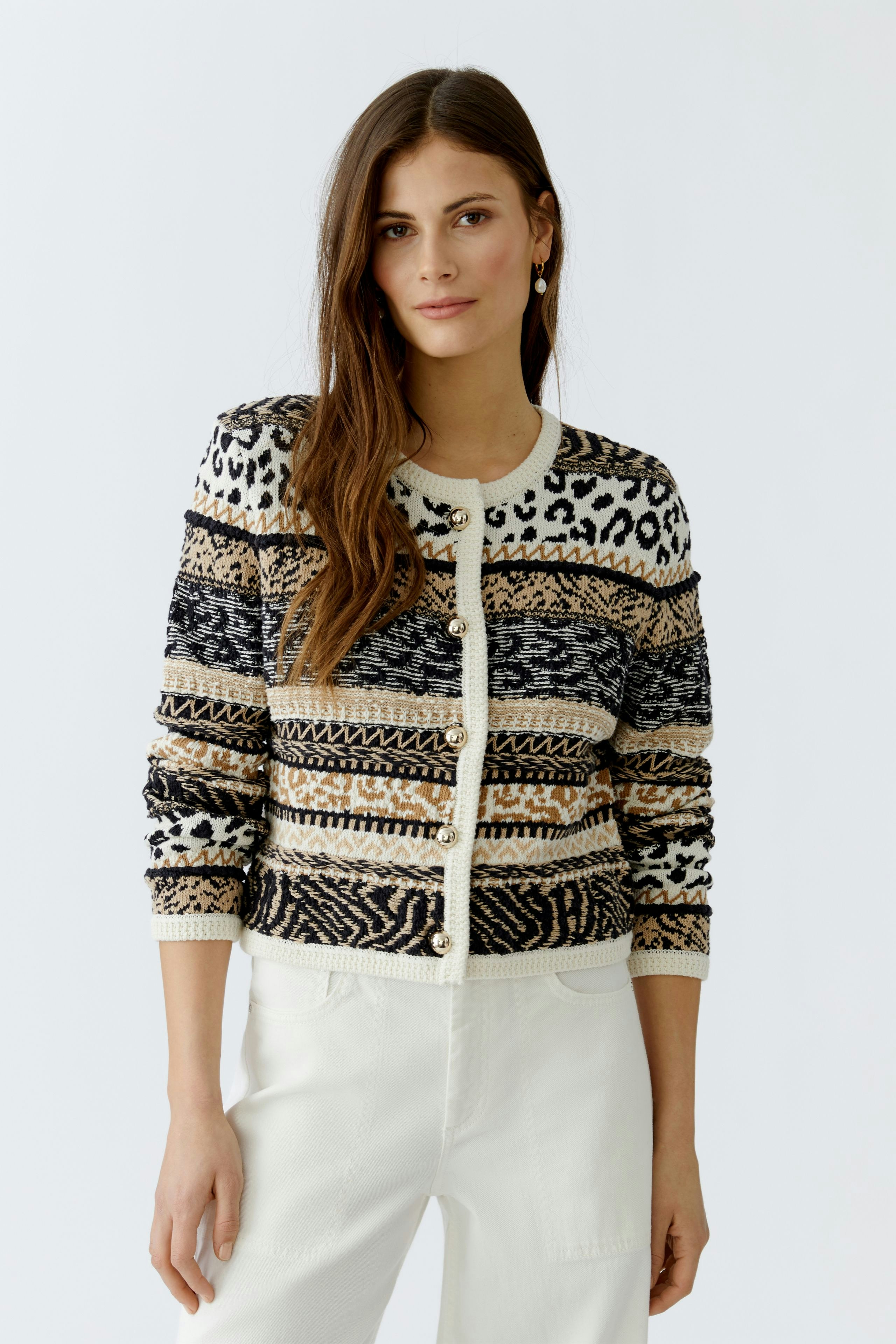 Stylish women's cardigan: A woman in a patterned cardigan with buttons and relaxed fit.