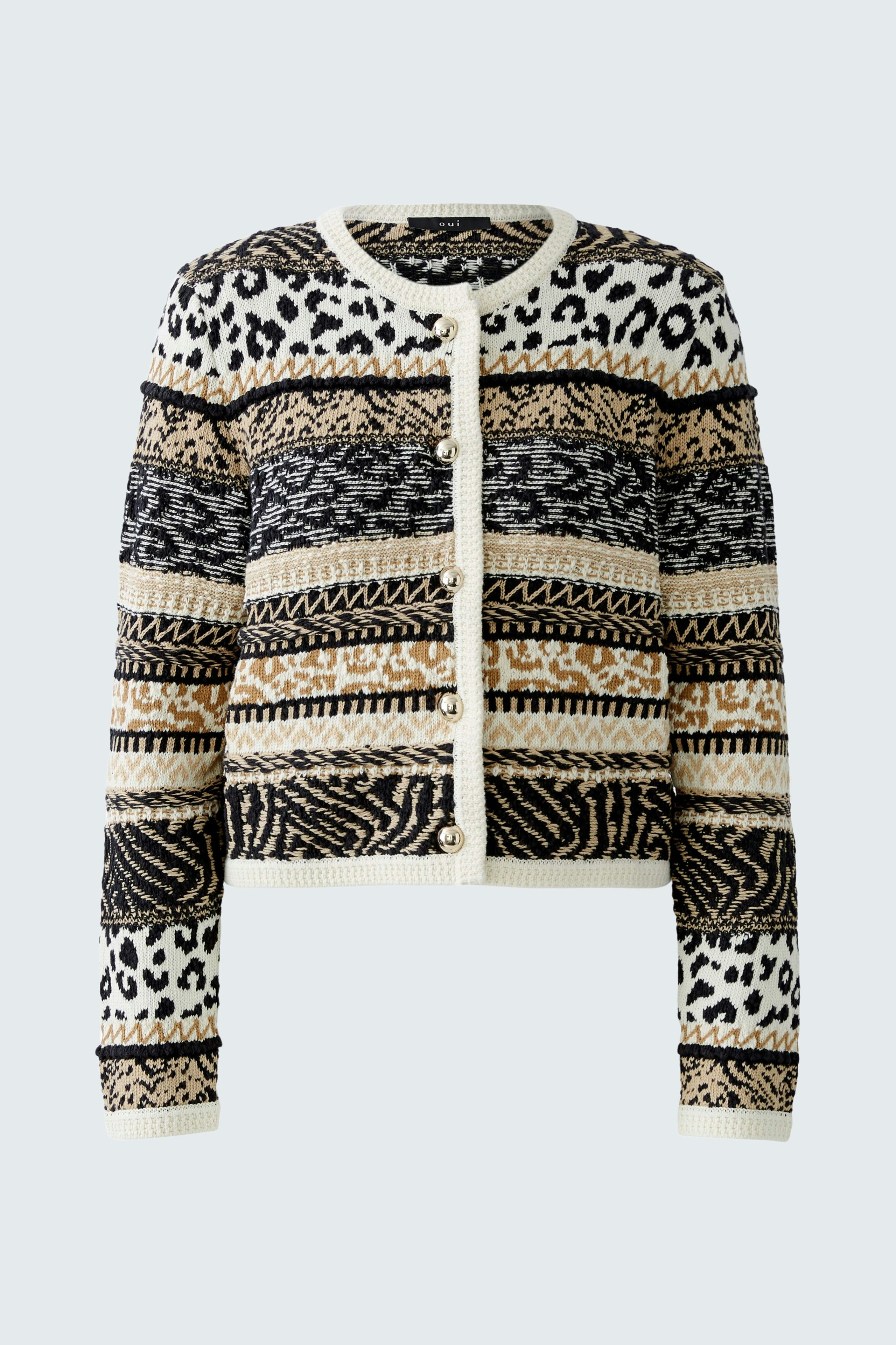 Stylish women's cardigan: A woman in a patterned black and cream cardigan with animal prints.