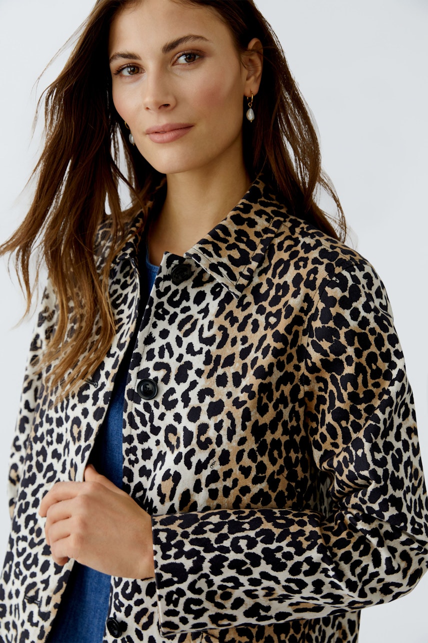 Stylish women's coat: A woman in a leopard print coat, showcasing a trendy and casual look.