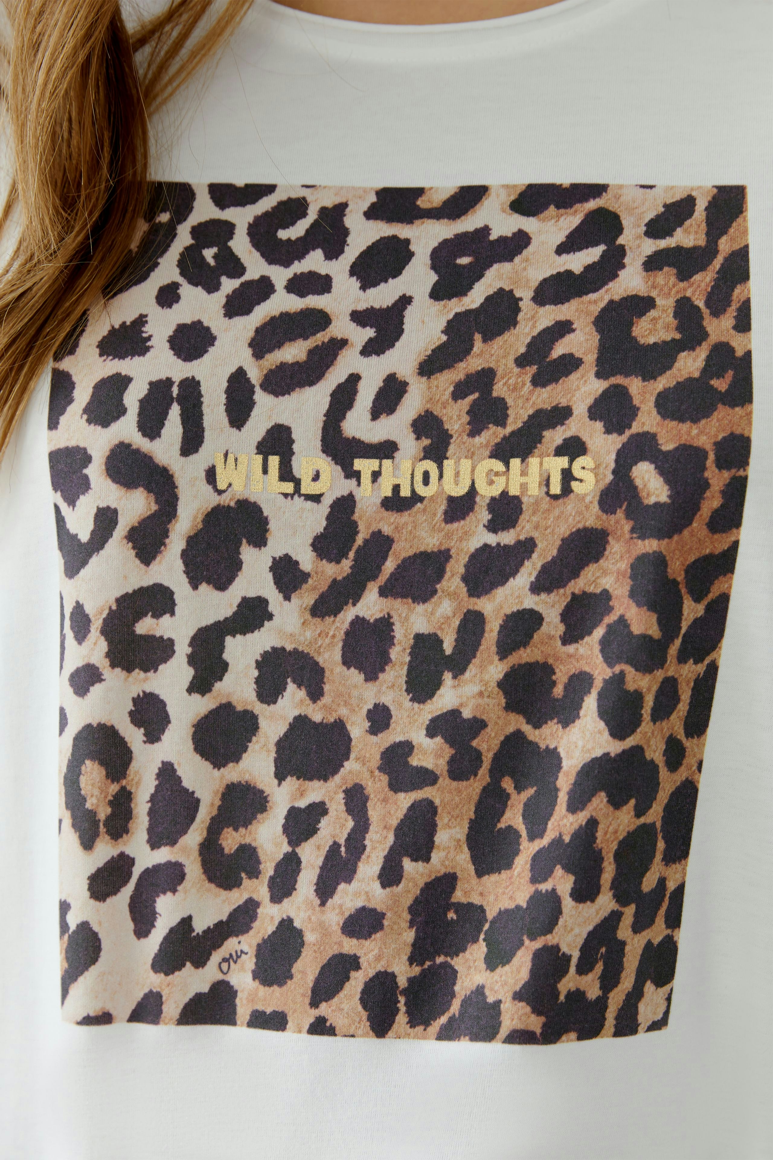 Casual women's T-shirt featuring a leopard print and 'WILD THOUGHTS' graphic.