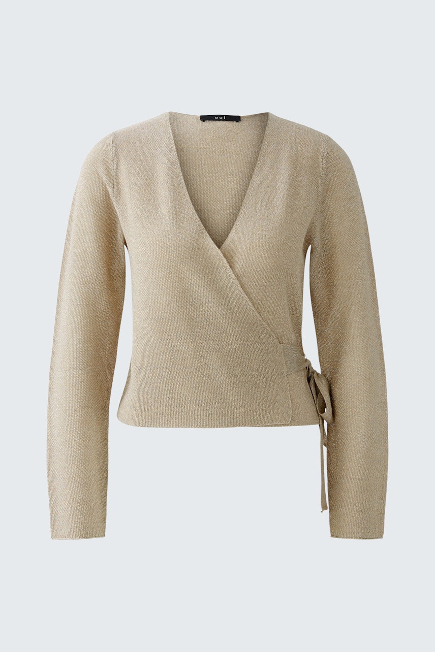 Casual women's cardigan: A woman in a beige wrap cardigan with long sleeves and a tie detail.