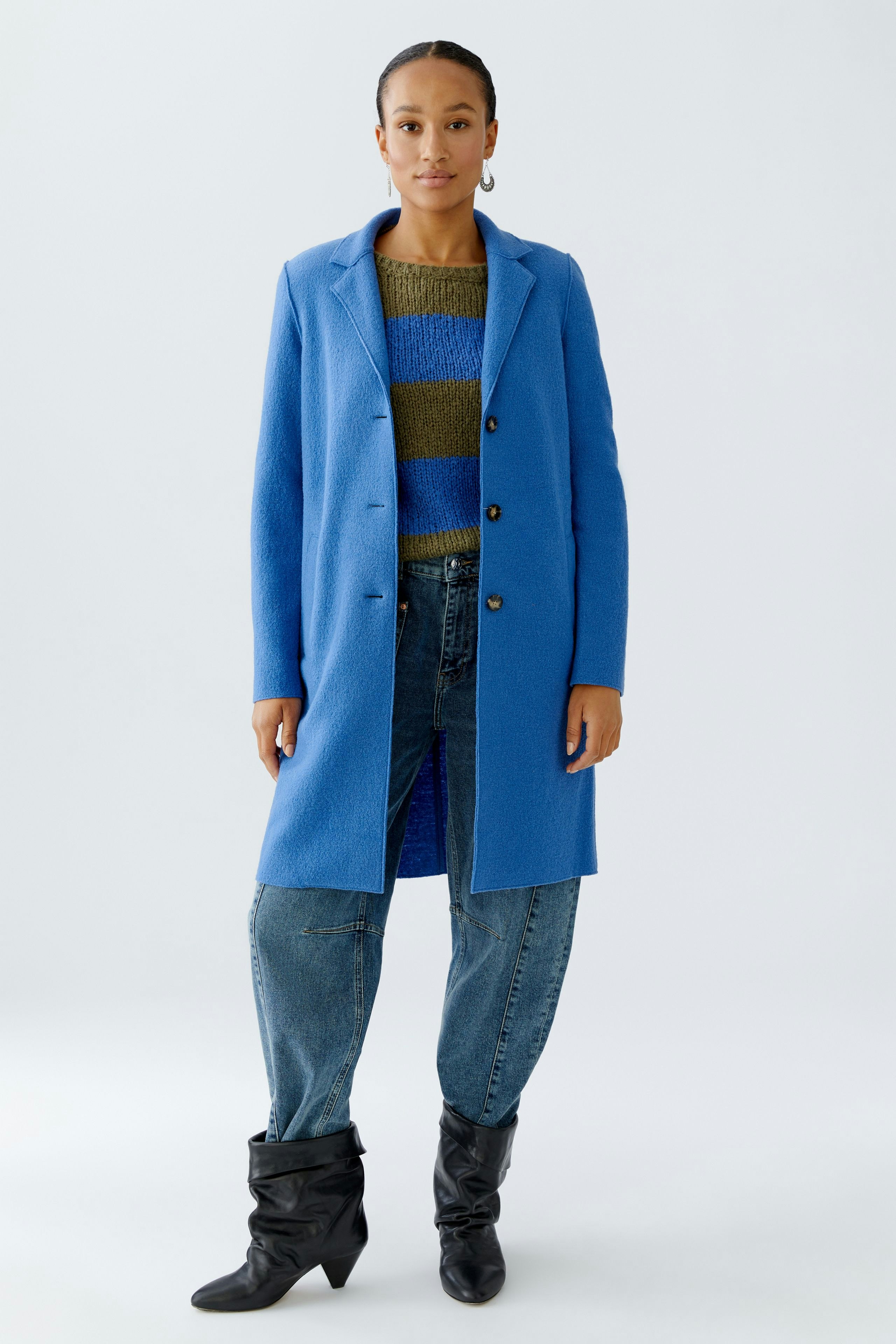 Wool coat: Woman in a blue wool coat over a striped pullover and relaxed jeans.