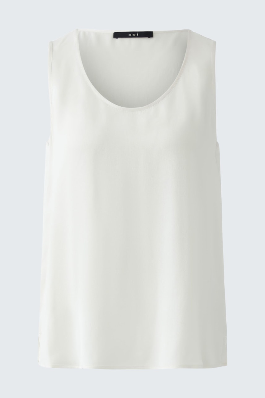 Casual women's top: A woman in a simple white sleeveless top, perfect for warm days.