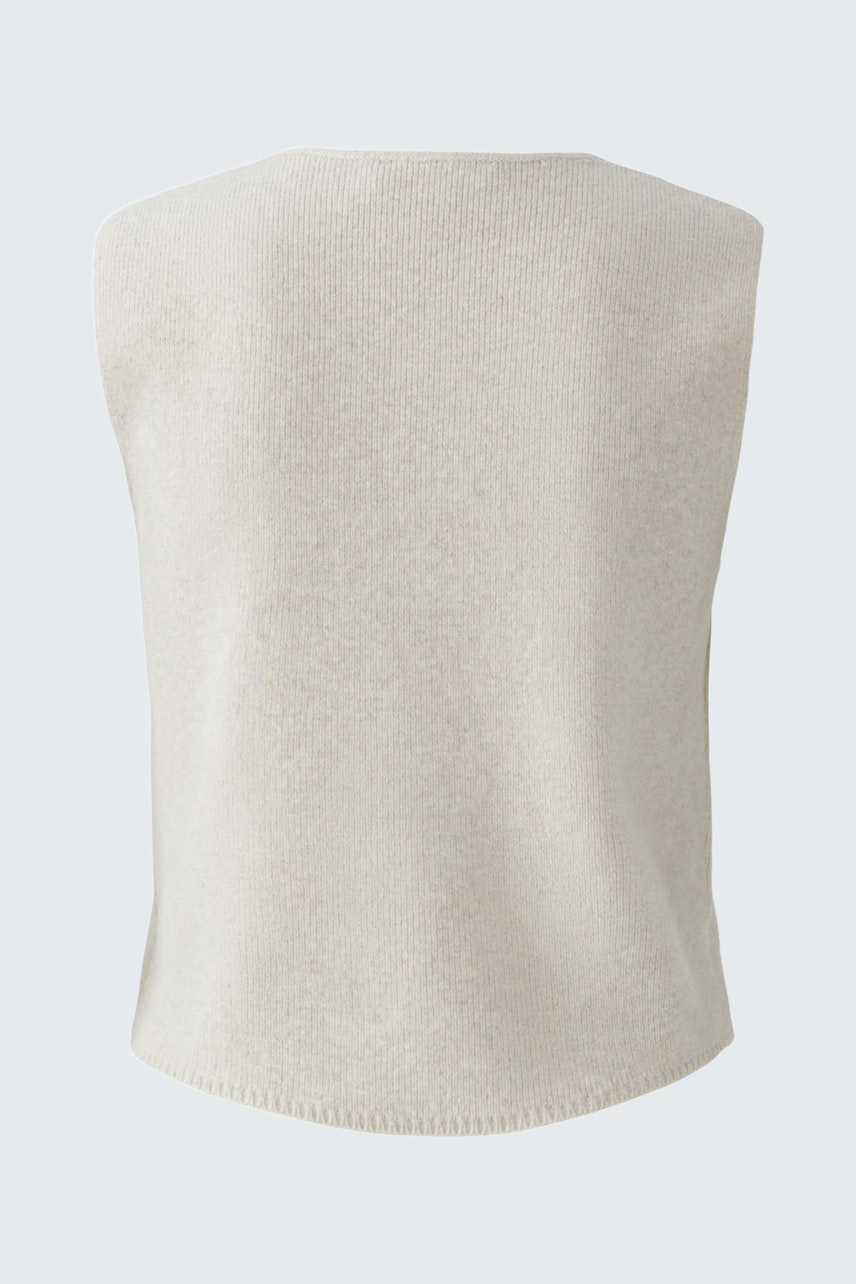 Casual women's knit vest in soft beige, perfect for layering and everyday wear.